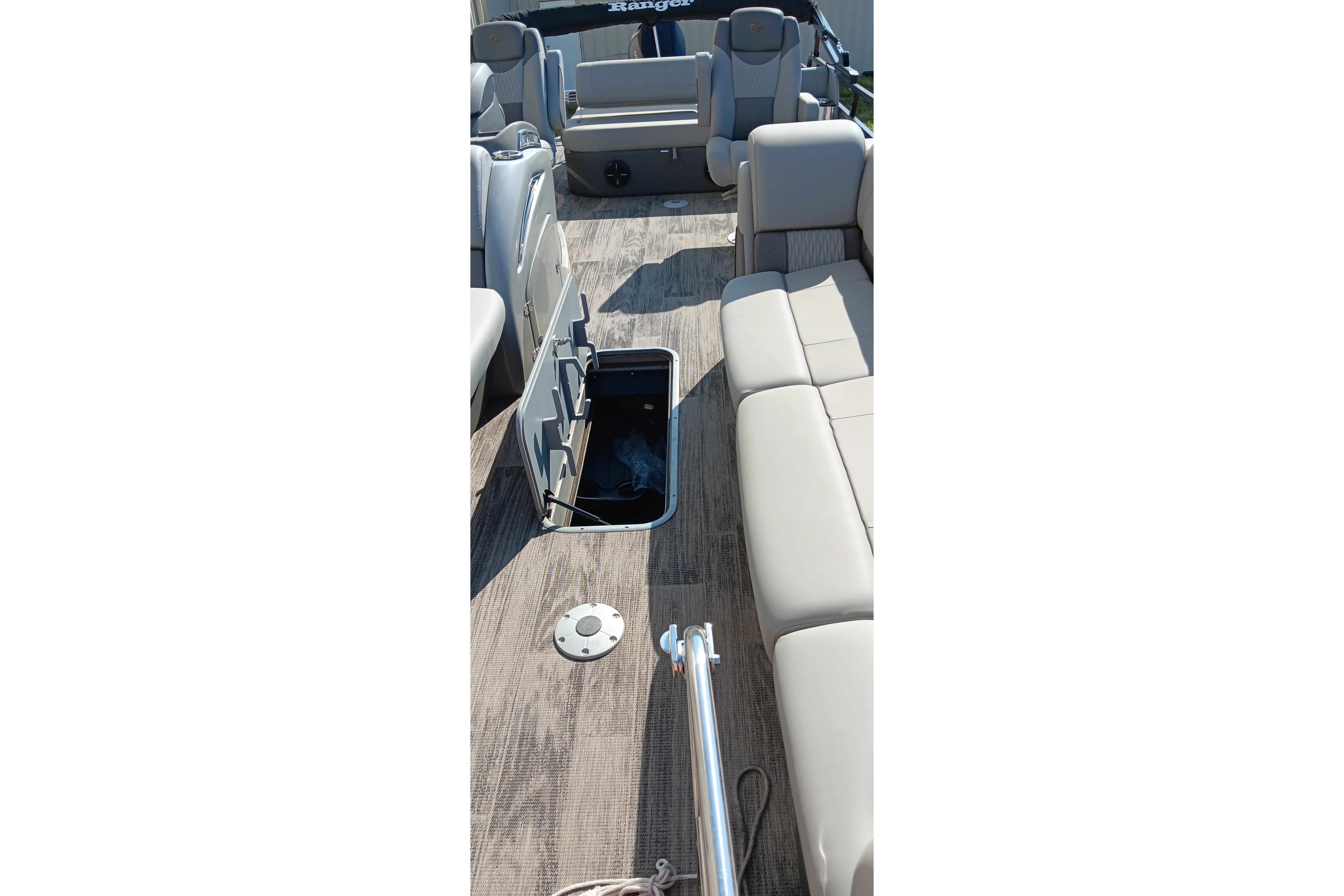 2023 Ranger 2500LS boat interior with open storage compartment and beige seating.