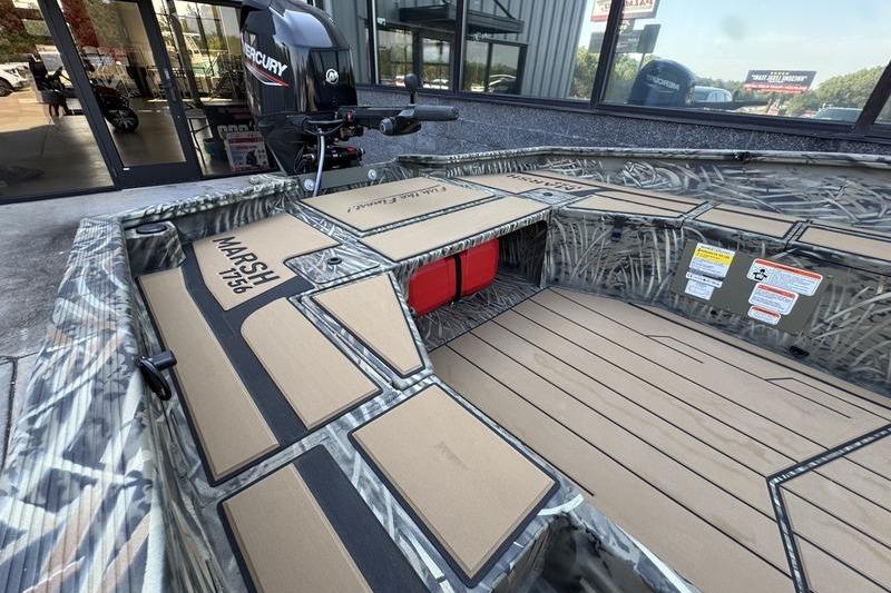 2026 Tracker Grizzly 1756 T Marsh boat interior with camo design and Mercury engine.