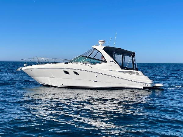2014 Sea Ray 330 Sundancer yacht cruising on open blue water.