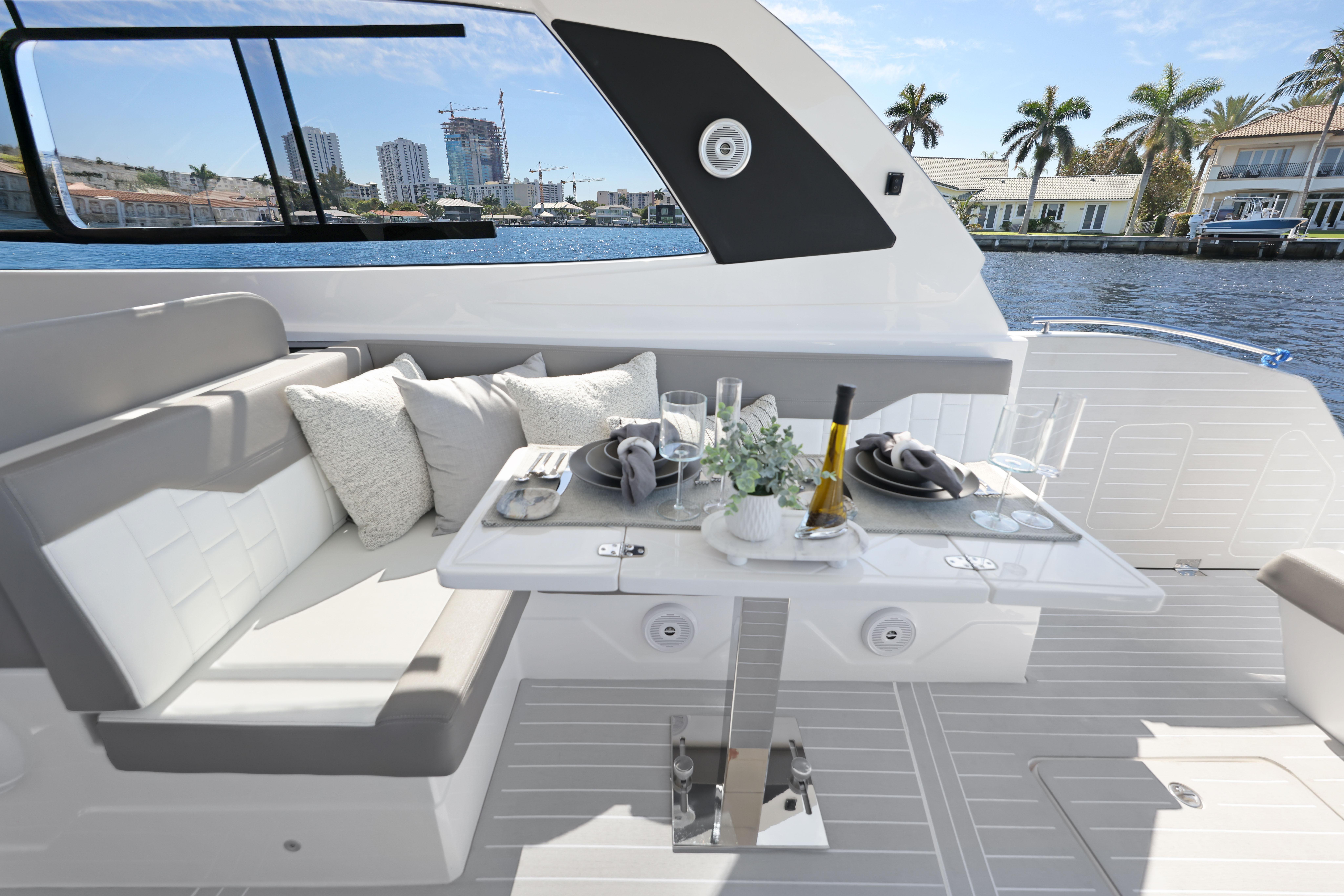 Luxurious interior of 2025 Valiatt 380 Bowrider yacht with elegant dining setup and waterfront view.