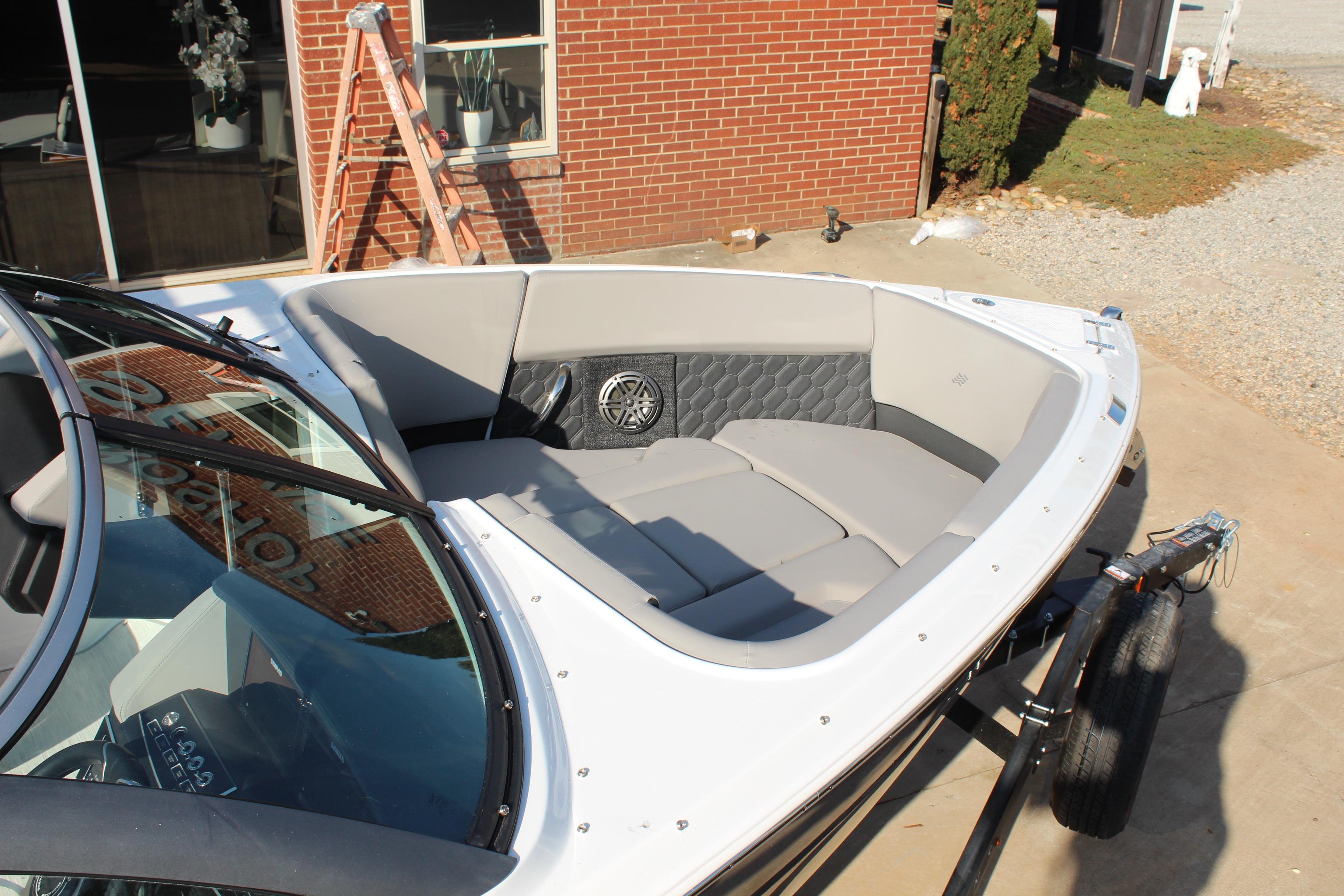 2026 Four Winns H4 boat with spacious seating and modern design, parked outdoors.