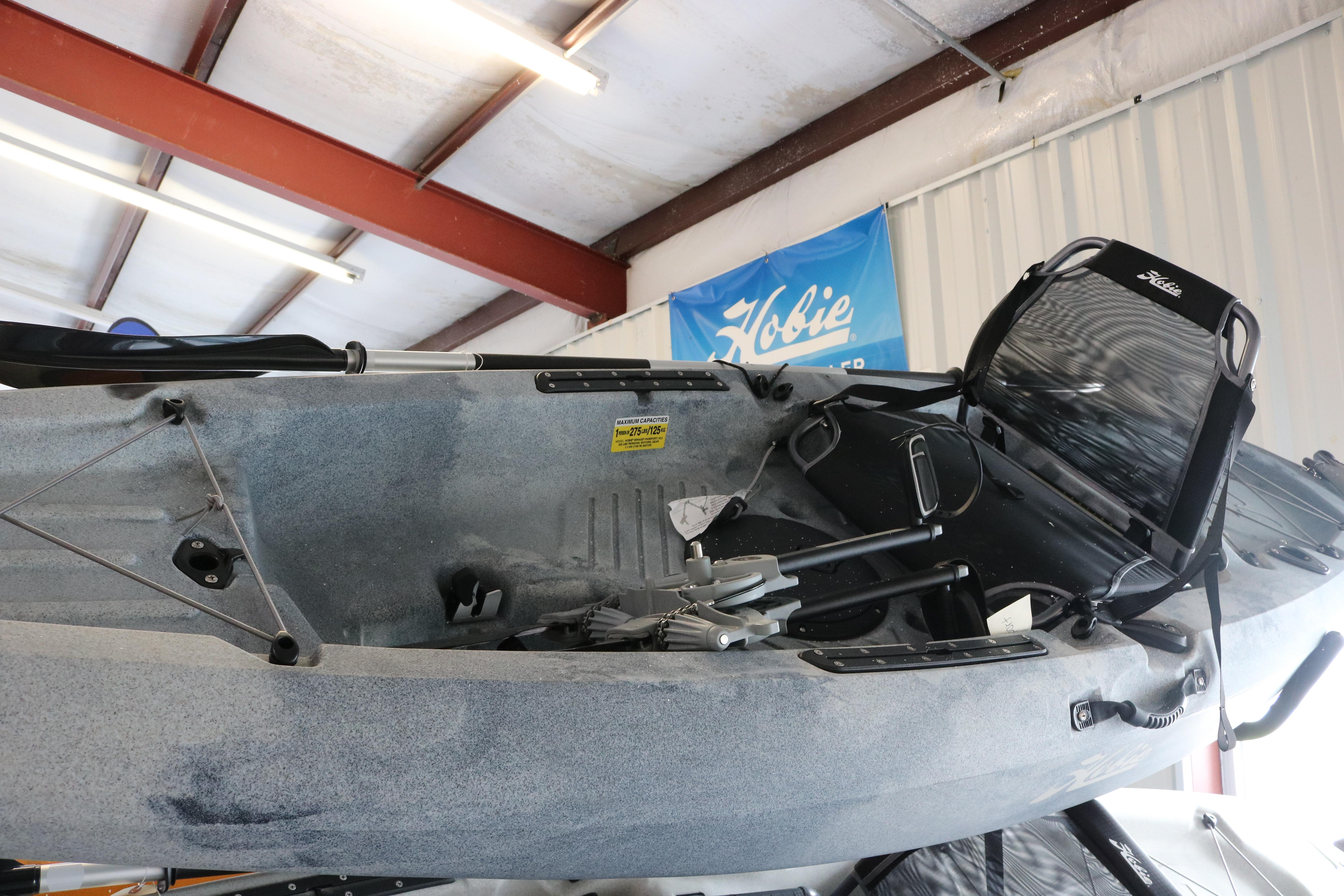 2024 Hobie Mirage Passport 10.5 R kayak displayed indoors with pedal drive system.