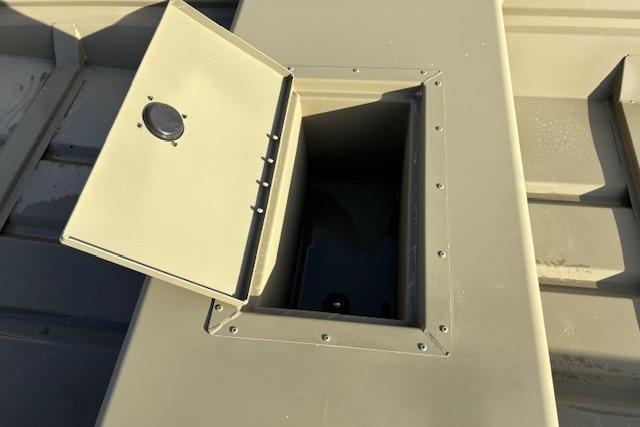 2026 Tracker Grizzly 15 Jon boat storage compartment with open lid, showcasing interior space.