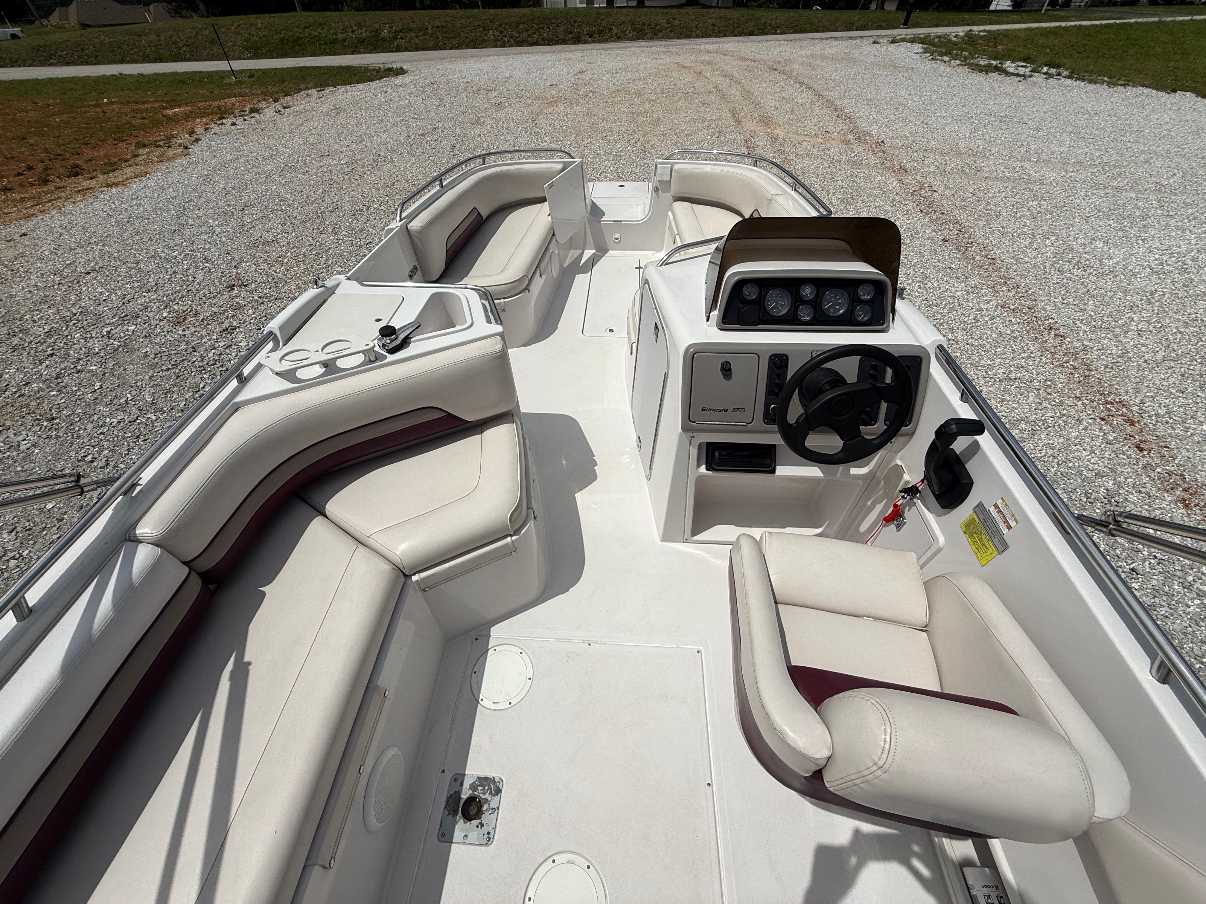 Interior view of a 1994 Chaparral Sunesta 220 boat with white seating and a helm console.