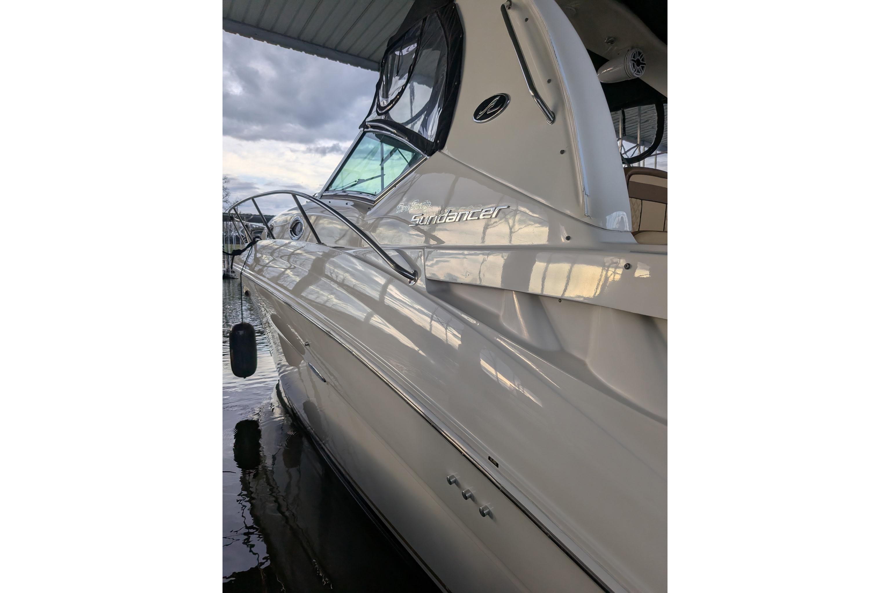A 2002 Sea Ray Sundancer 320 is docked on the water.