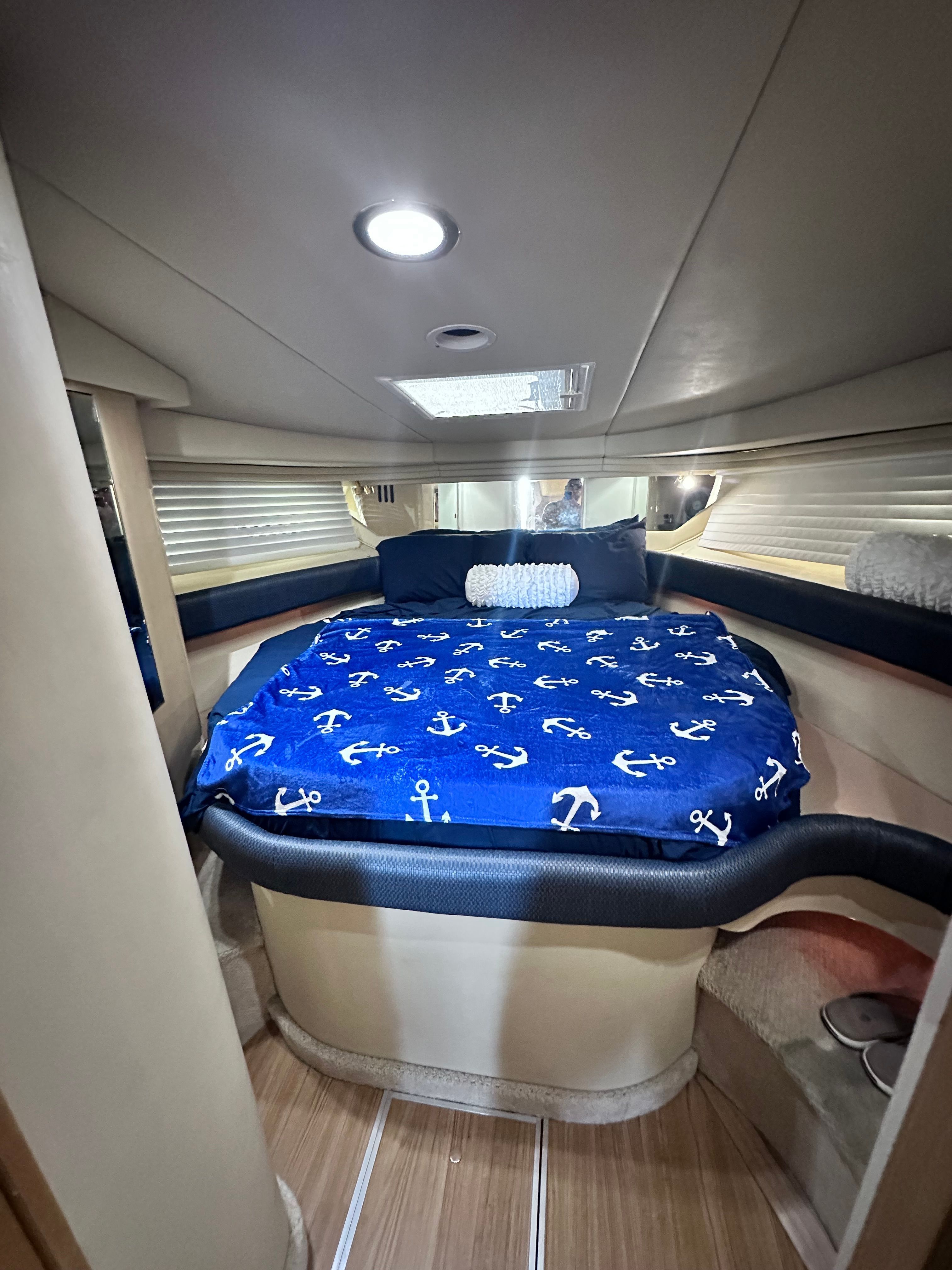 Interior cabin of 2000 Sea Ray 380 Sundancer with anchor-themed bedding.