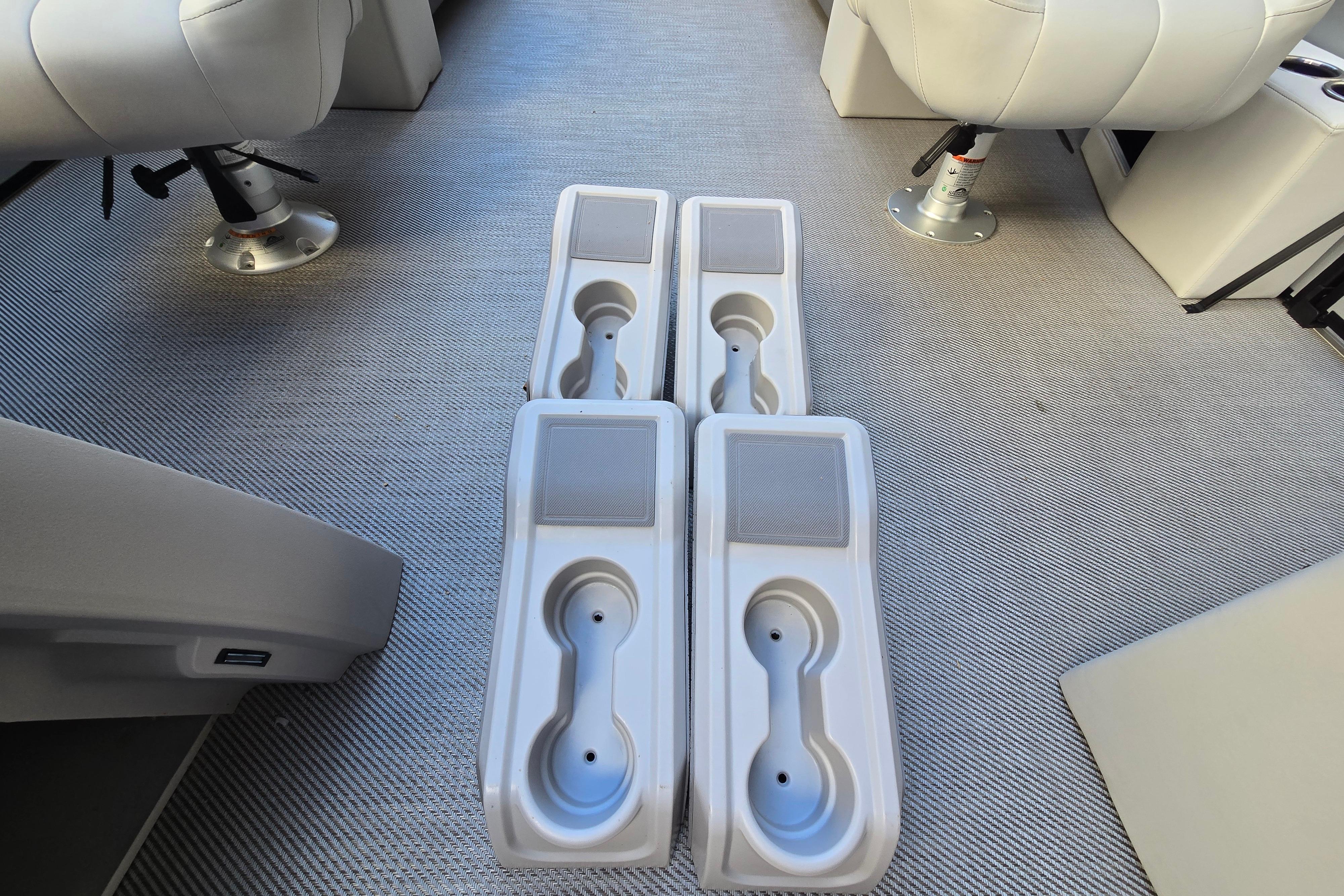 Interior of 2024 Godfrey Sweetwater 2486 SB boat with cup holders and seating.