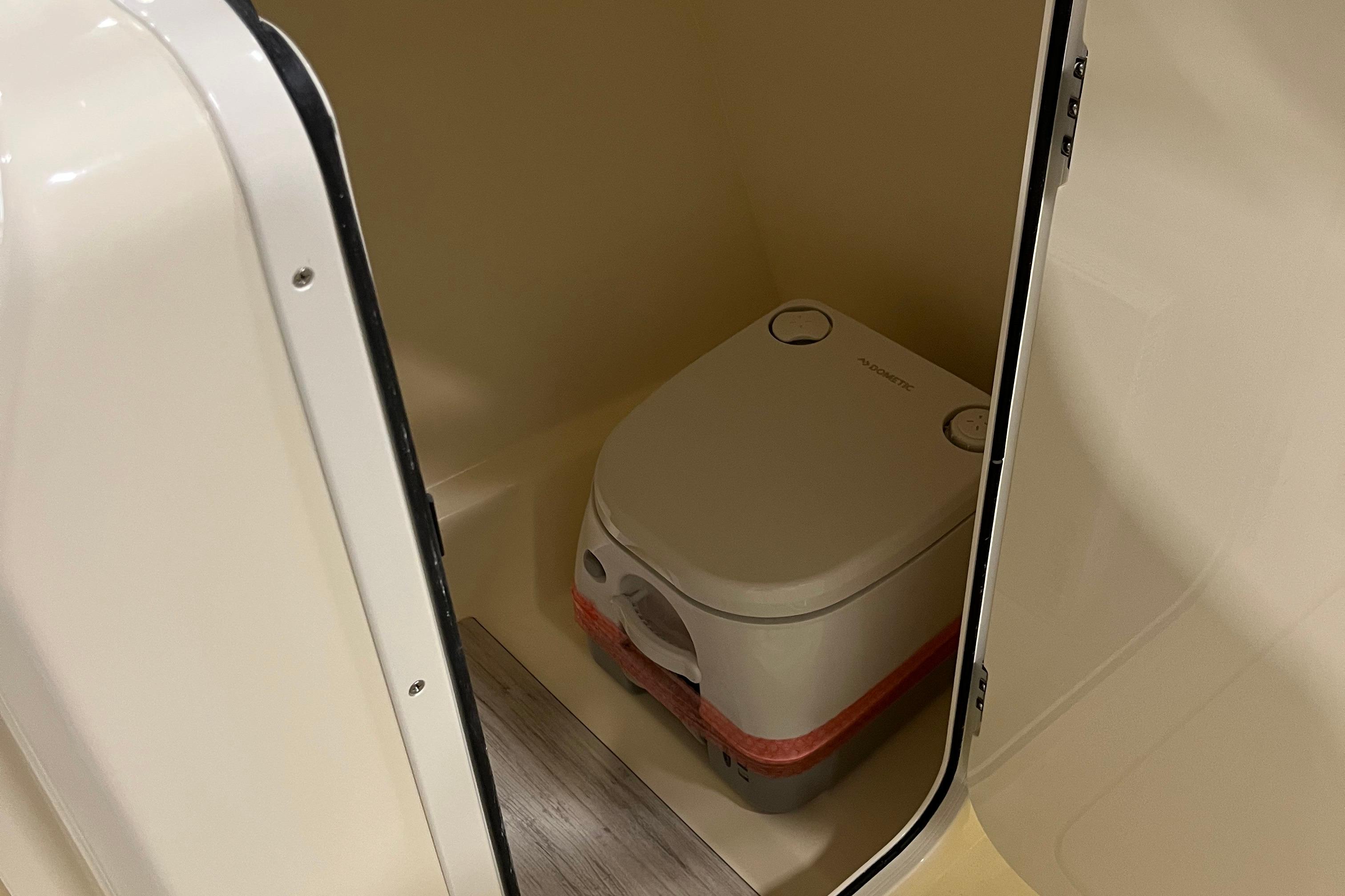 Portable toilet inside 2025 Scout 215 Dorado boat compartment.