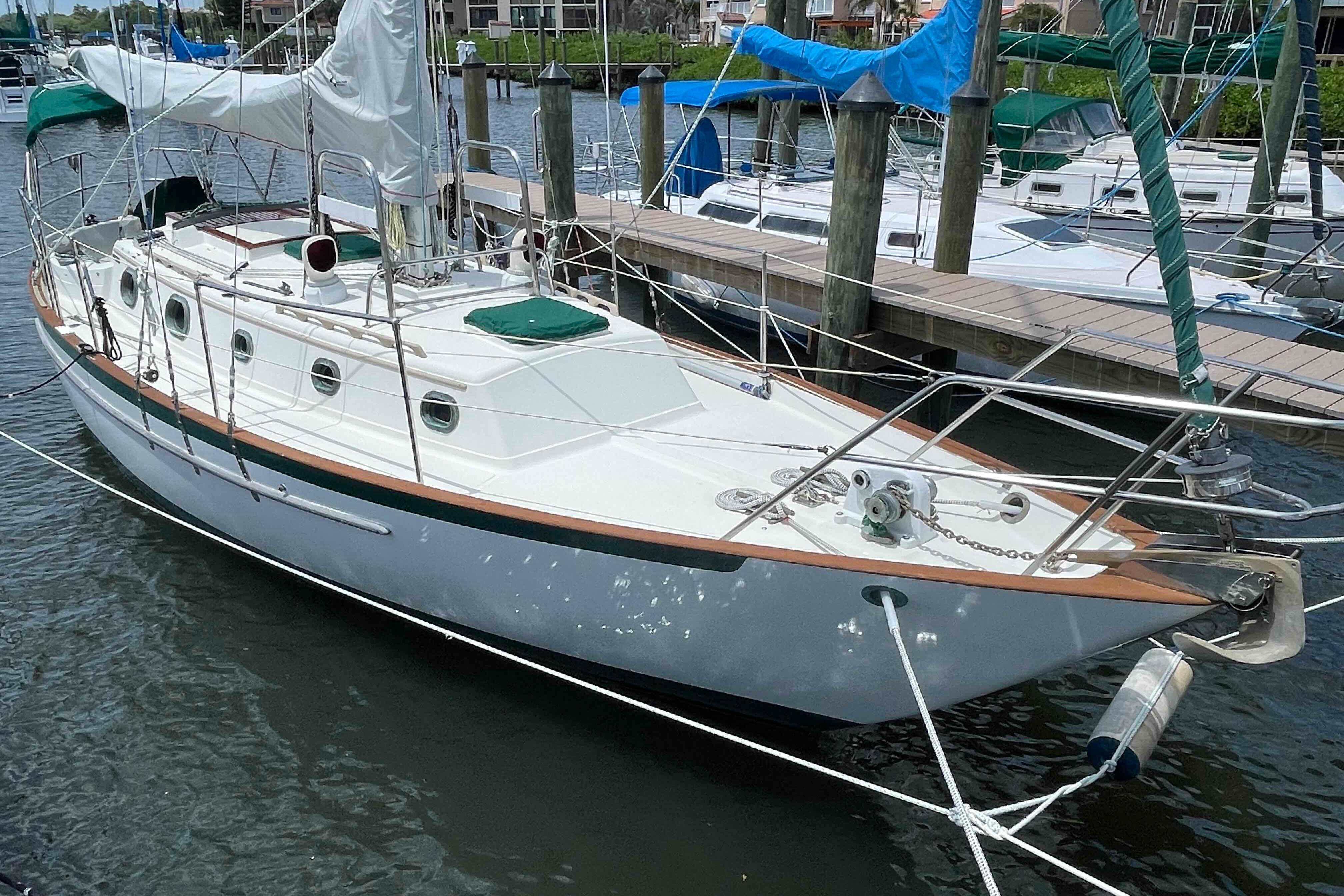 1987 Pacific Seacraft 34 sailboat docked in a marina, featuring classic design and white hull.