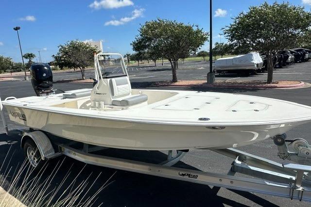 2026 Mako 18 Pro Skiff boat on trailer in sunny parking lot.