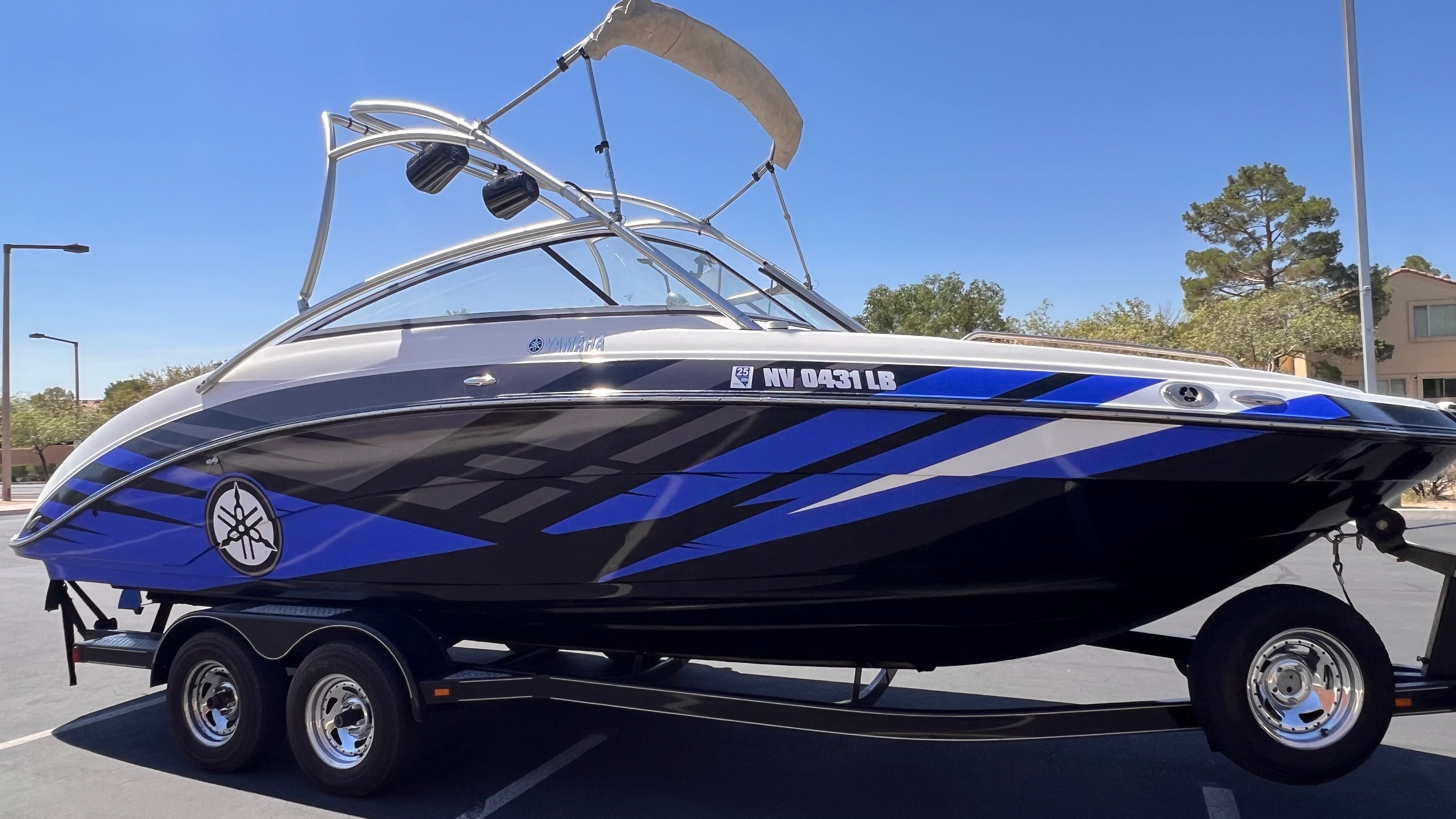 2011 Yamaha AR240 HO boat on trailer, blue and black design.