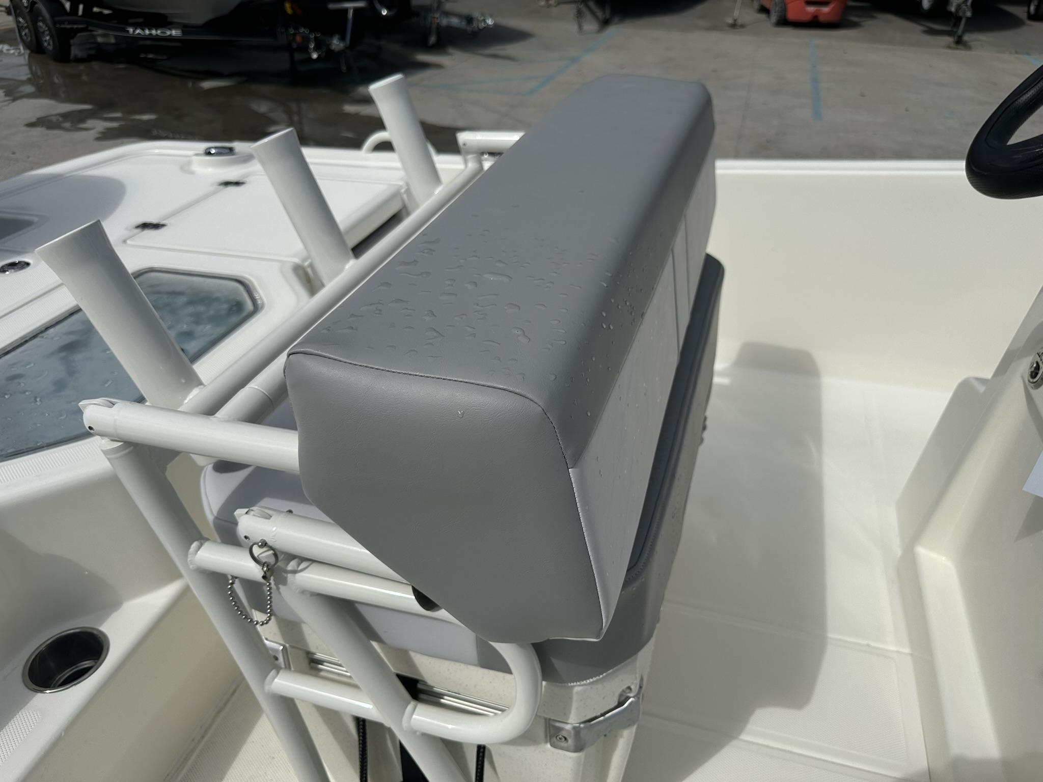 2024 Mako Pro Skiff 19 CC boat seat with rod holders and wet surface.