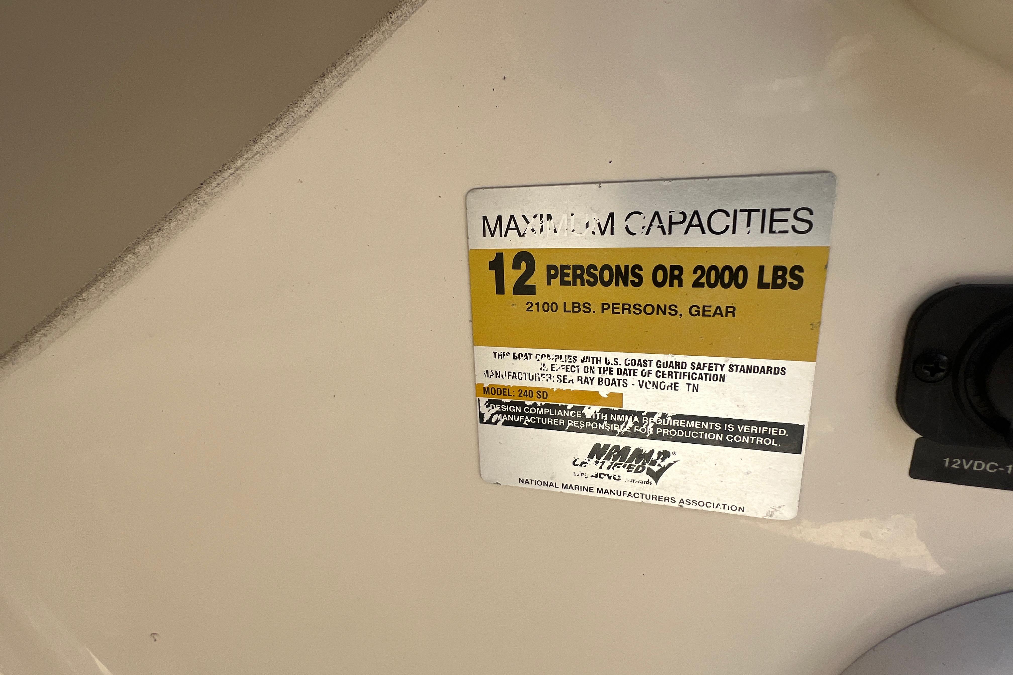 Capacity label on 2005 Sea Ray 240 Sundeck, max 12 persons or 2000 lbs.