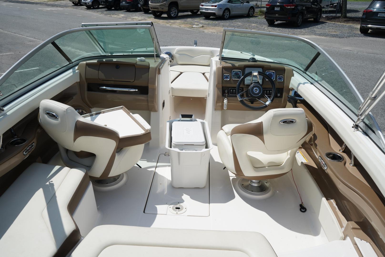 Interior view of a 2013 Chaparral 206 SSi boat with seating and steering wheel.