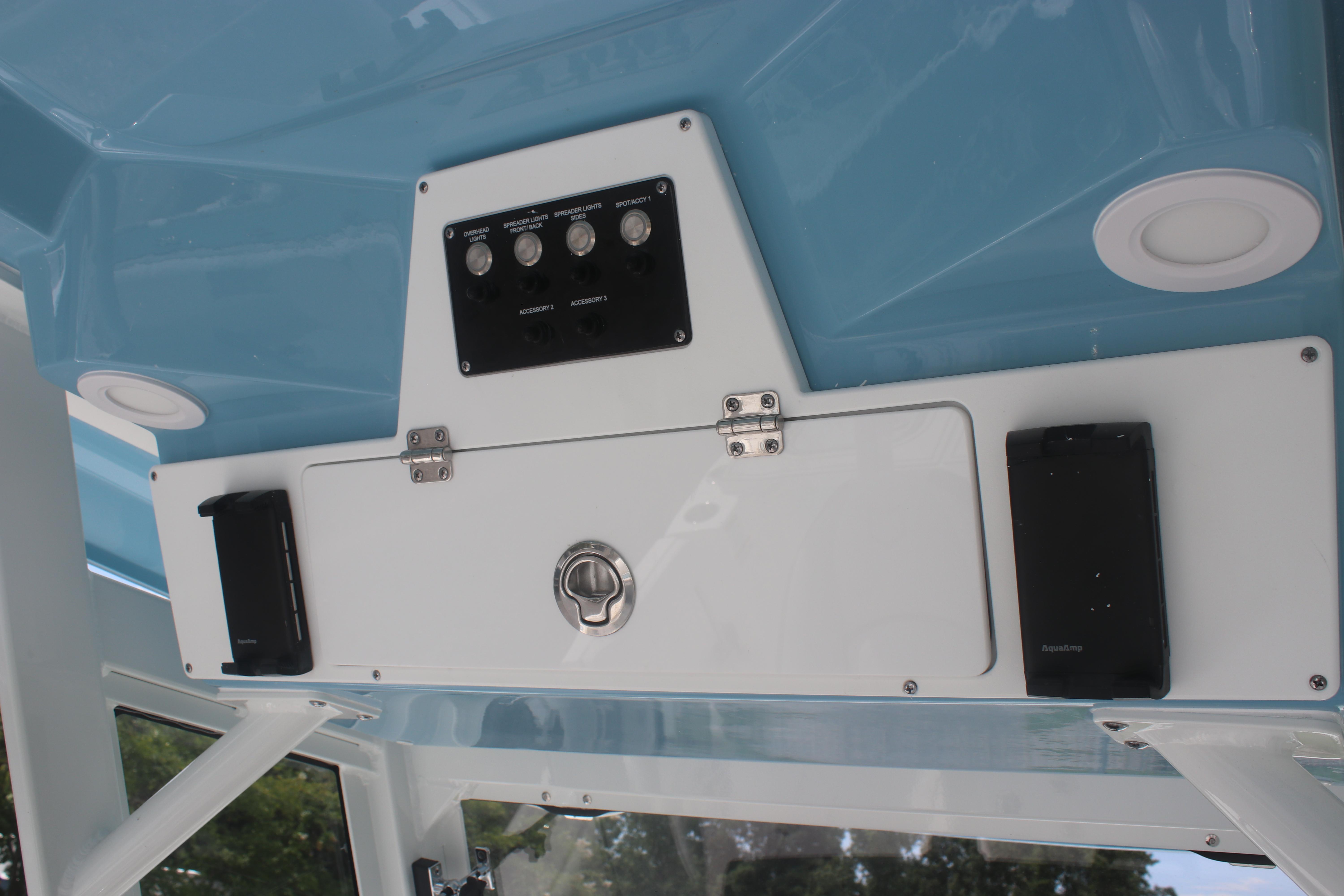 Control panel of 2026 Sea Fox 288 Commander boat with switches and storage compartment.
