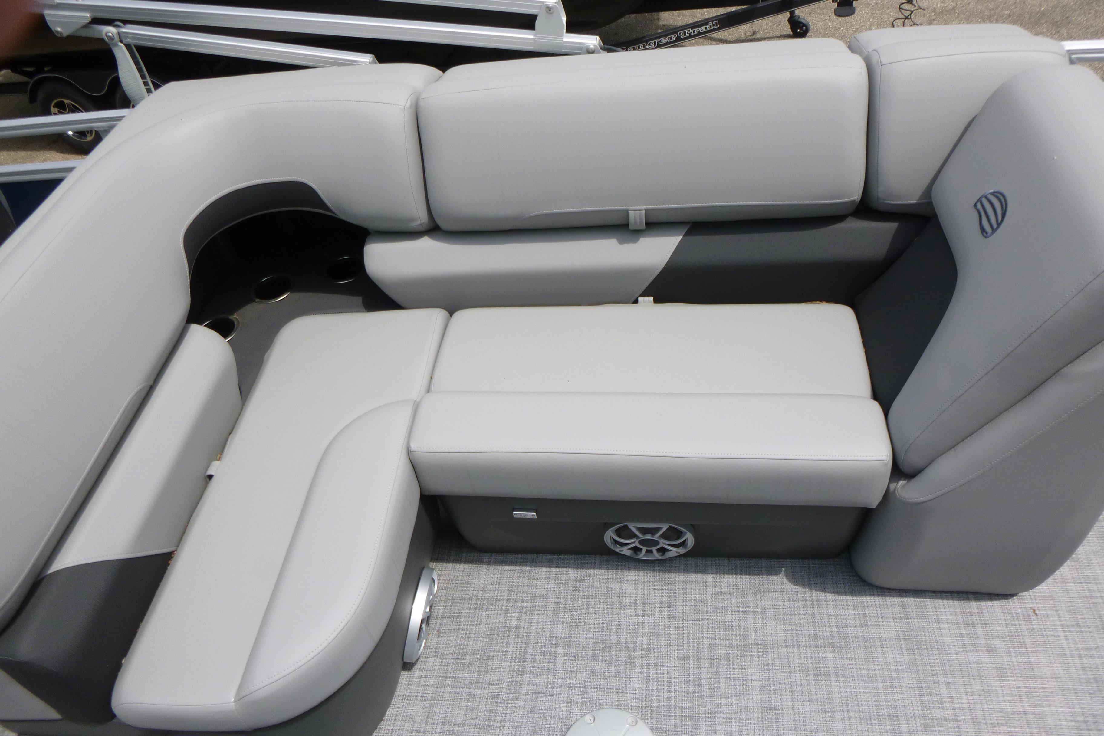 Luxurious seating on 2026 Sun Tracker SportFish 22 DLX pontoon boat, featuring sleek gray upholstery.