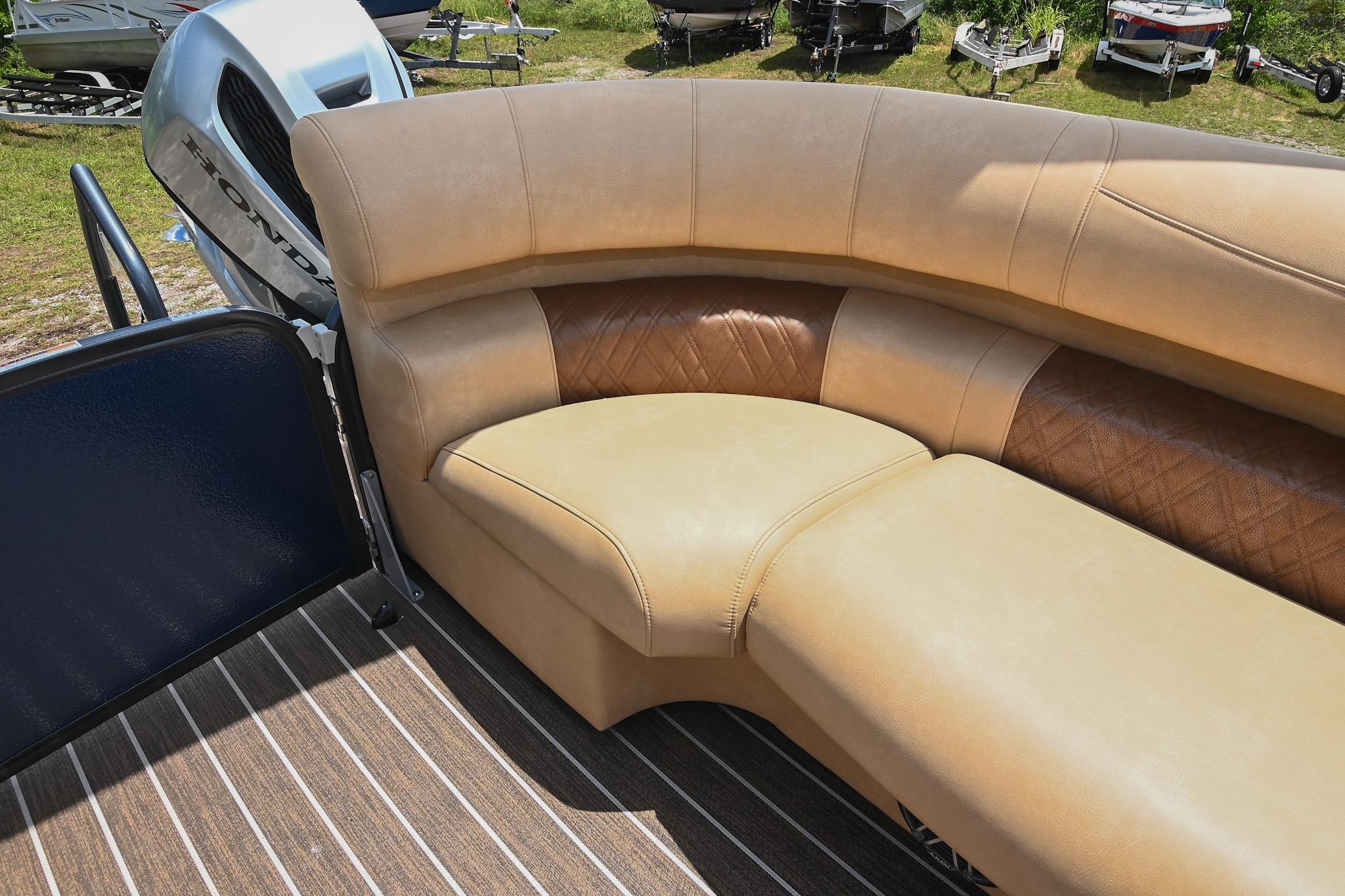 Luxurious seating on 2023 Premier 270 Intrigue RF boat with Honda engine in background.