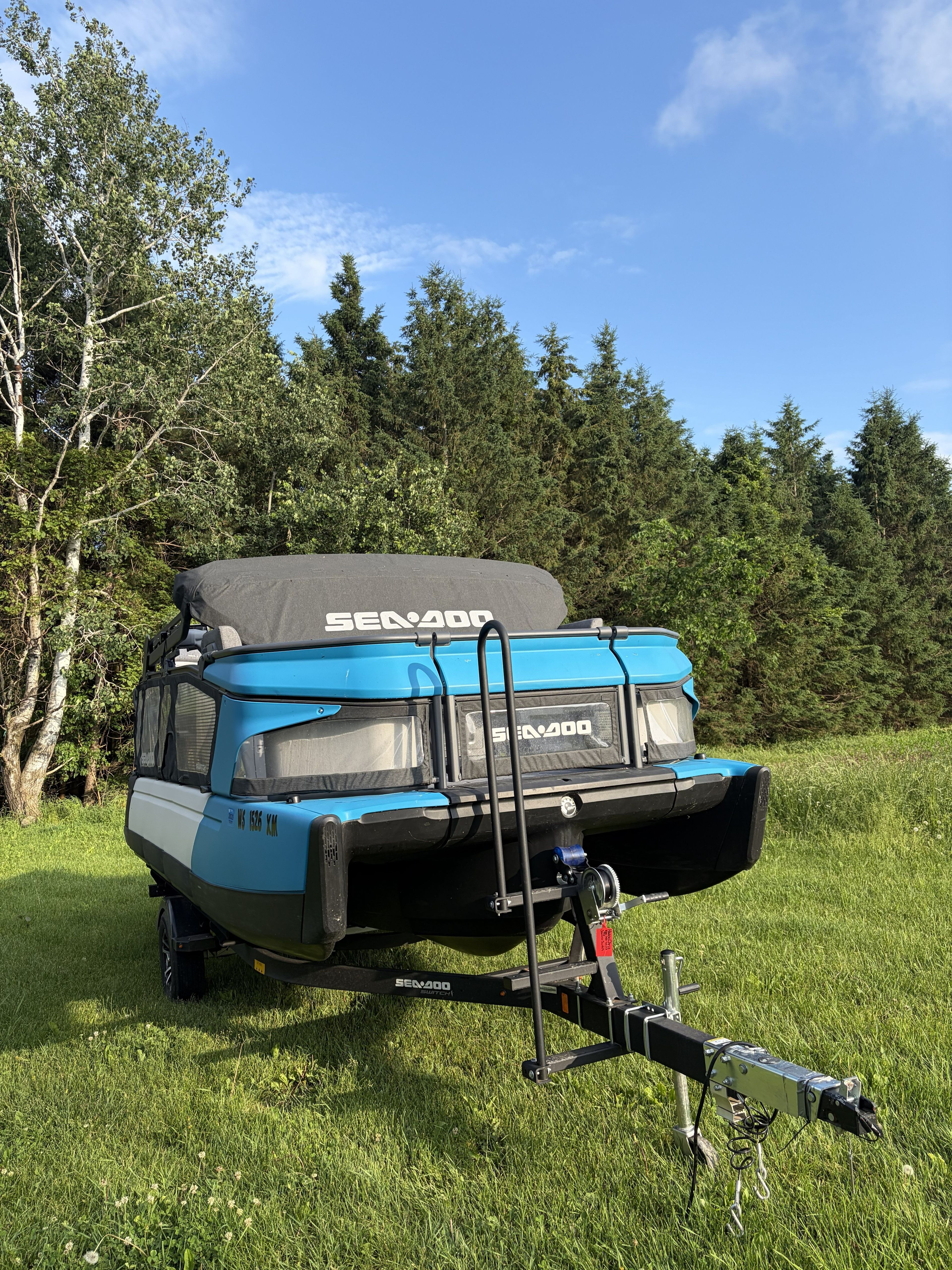 2023 Custom Sea Doo Switch on a trailer in a grassy area.