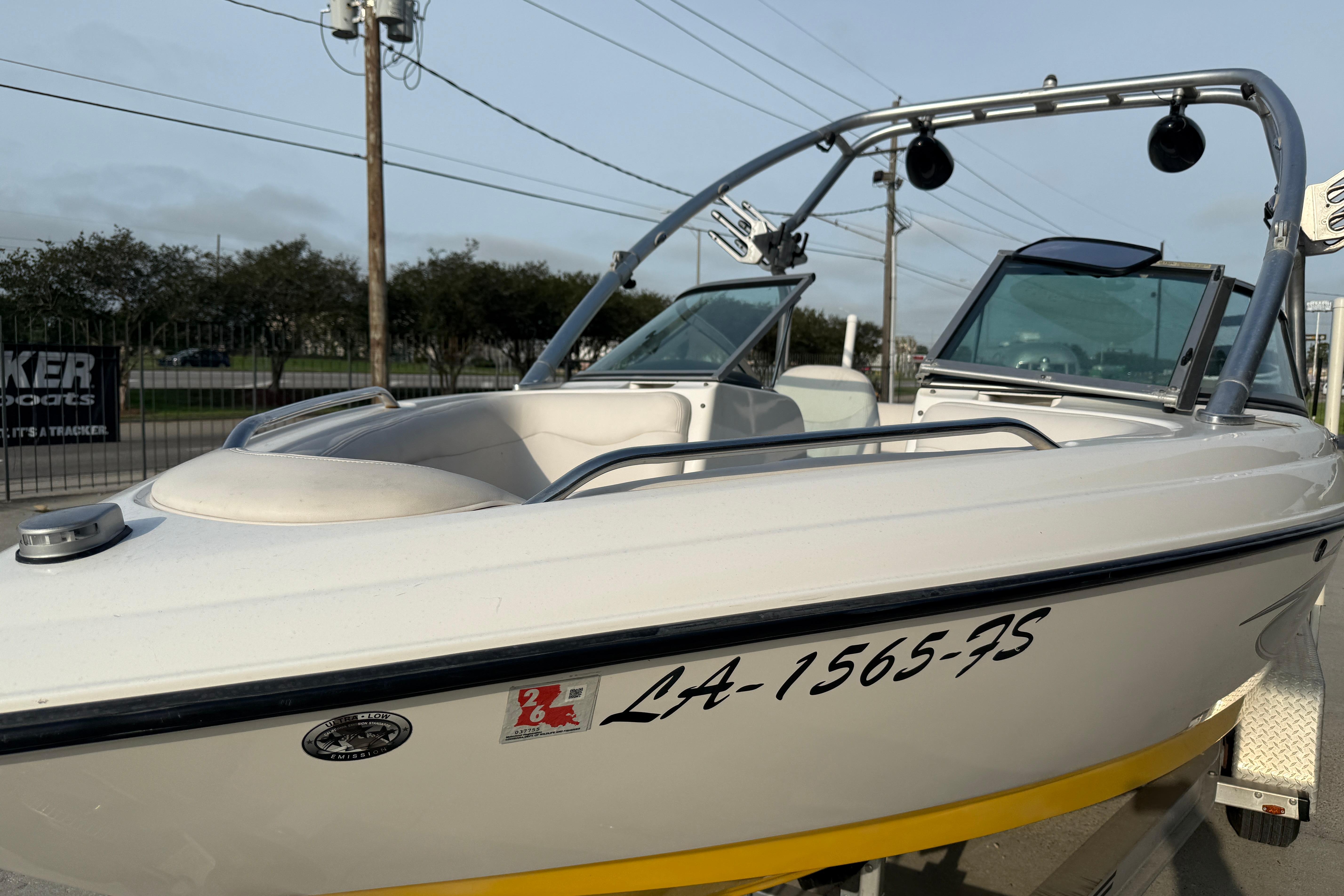 2005 MasterCraft X10 boat with registration number, parked on a trailer.