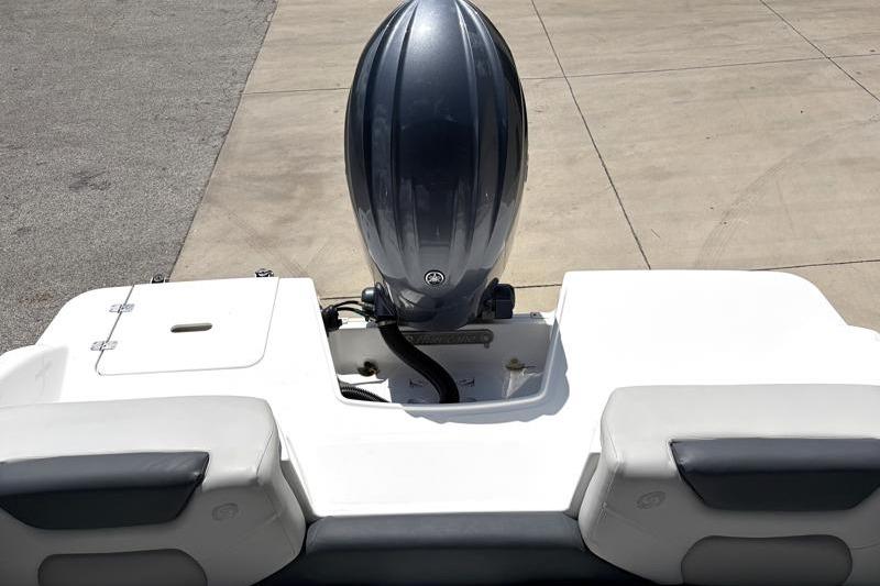 2026 Hurricane SunDeck Sport 2050 OB boat with outboard motor, rear view.