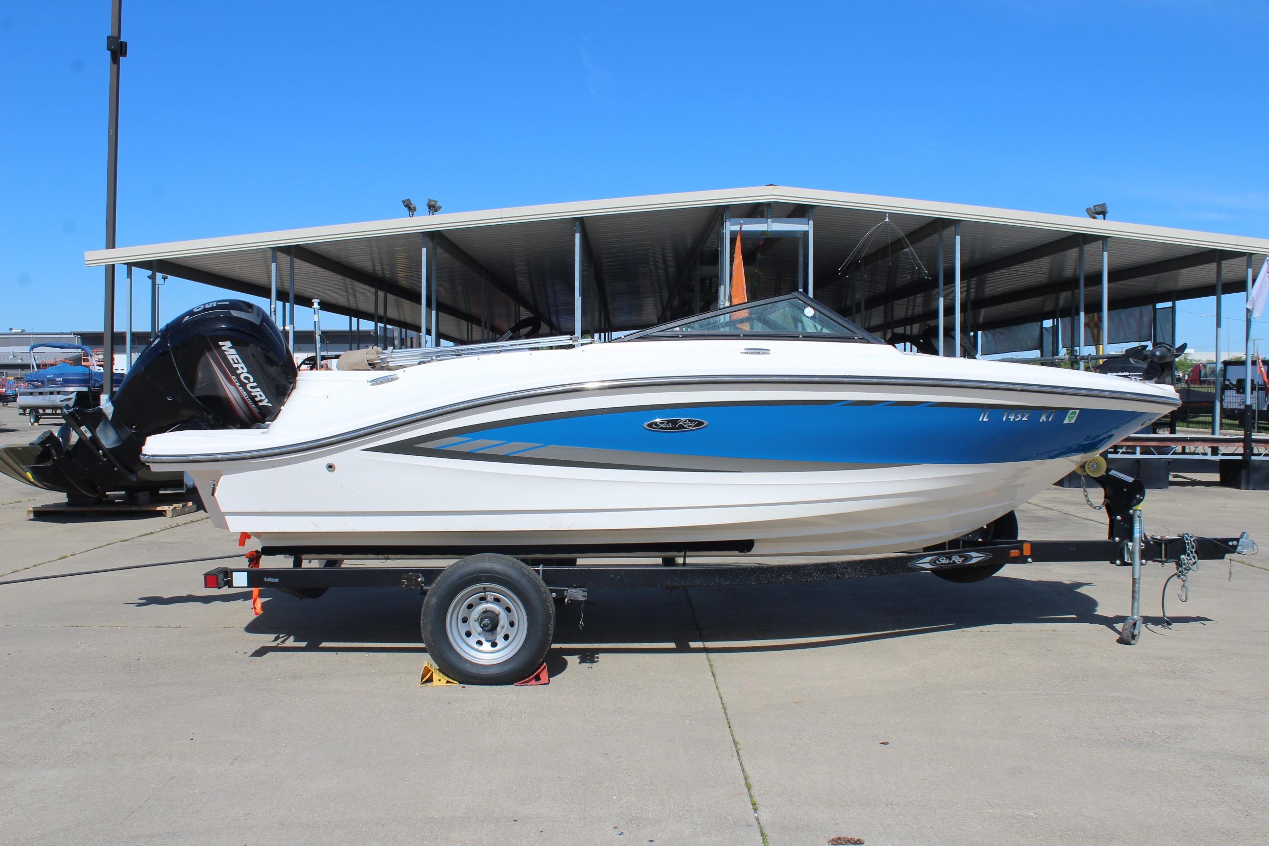 2015 Sea Ray 19 SPX OB boat on trailer, parked at marina under clear blue sky.