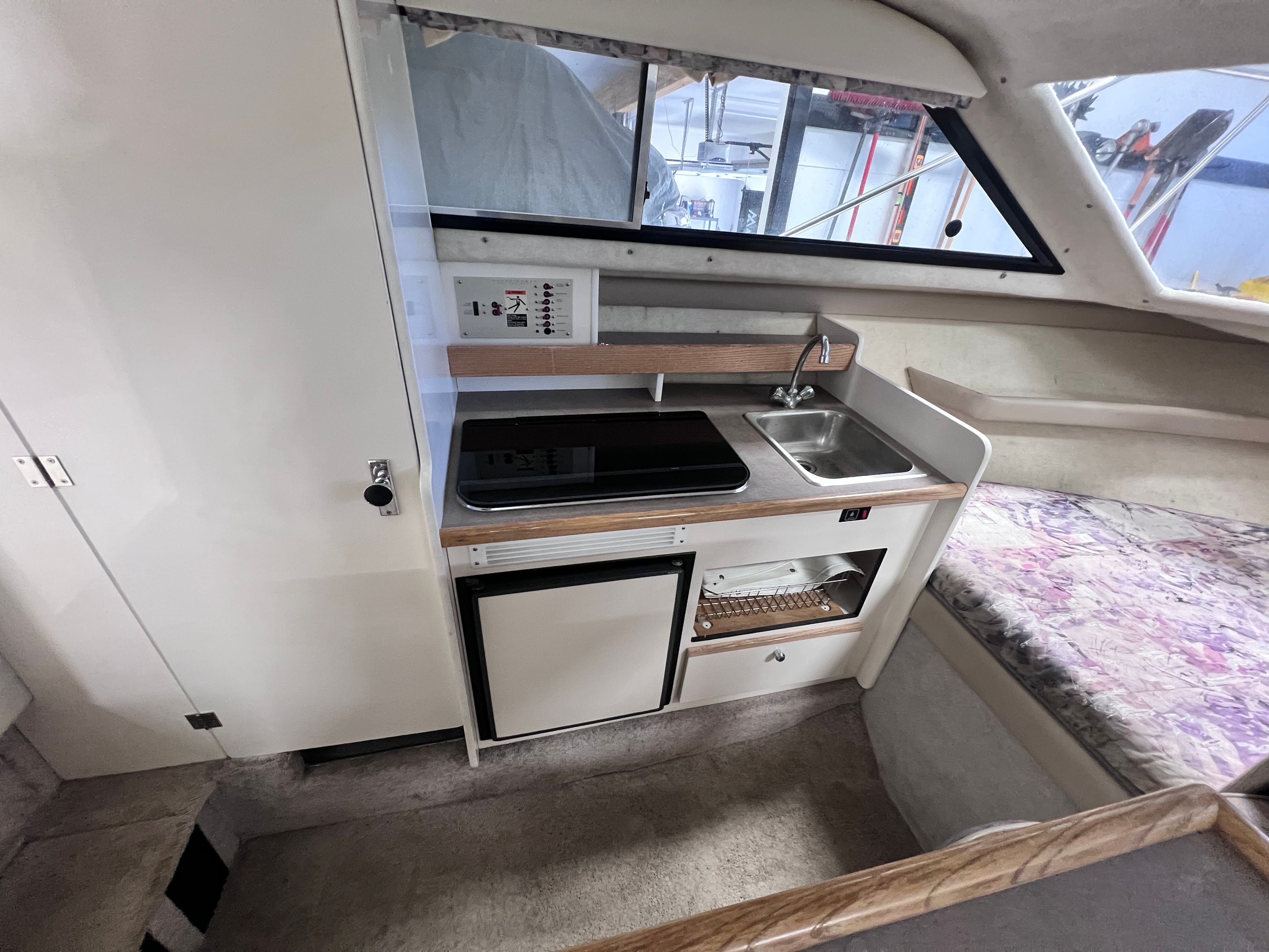 1997 Bayliner 2452 interior with kitchenette and sleeping area.