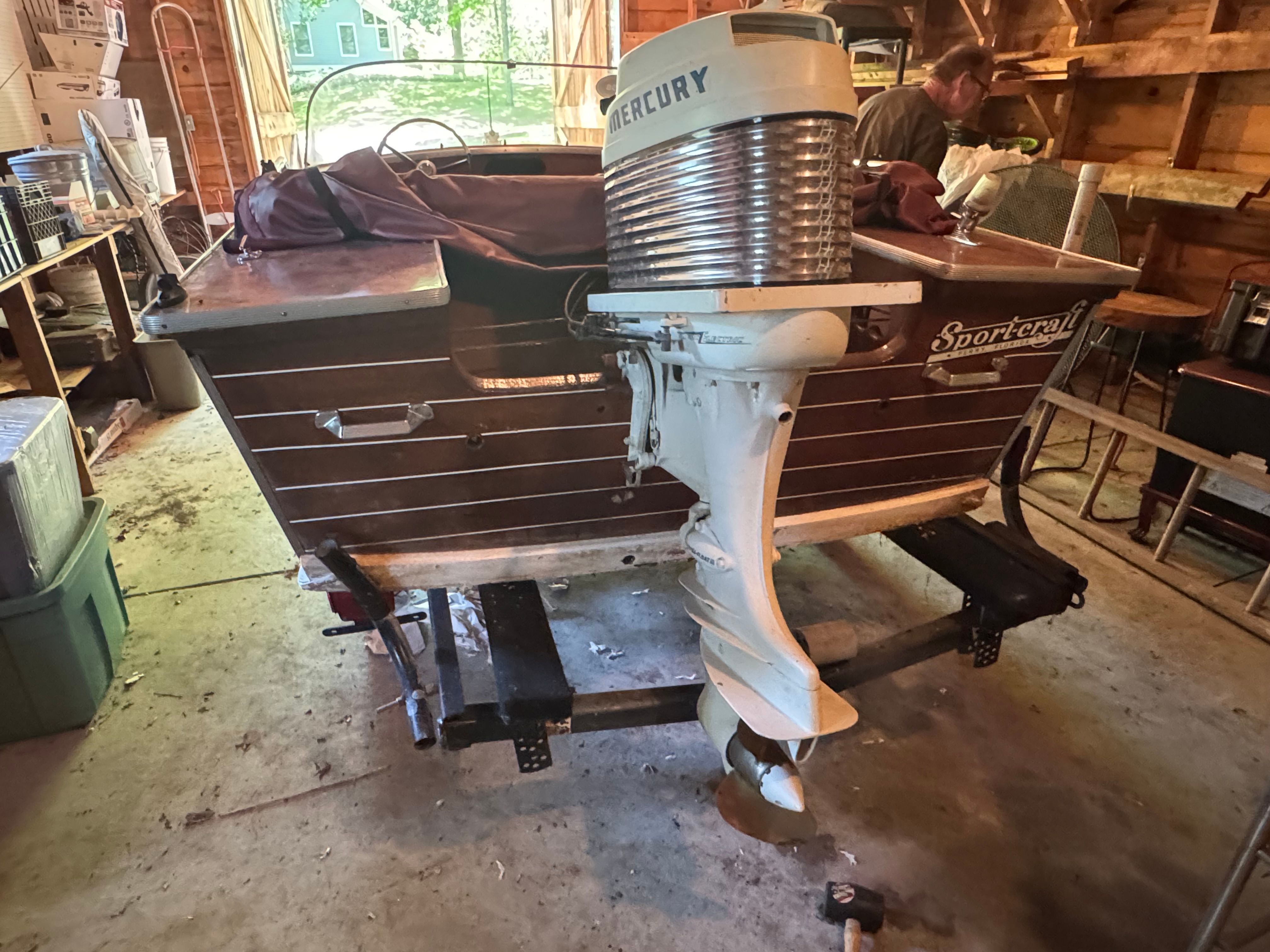 1958 Classic Sportcraft Runabout with Mercury engine in a garage.