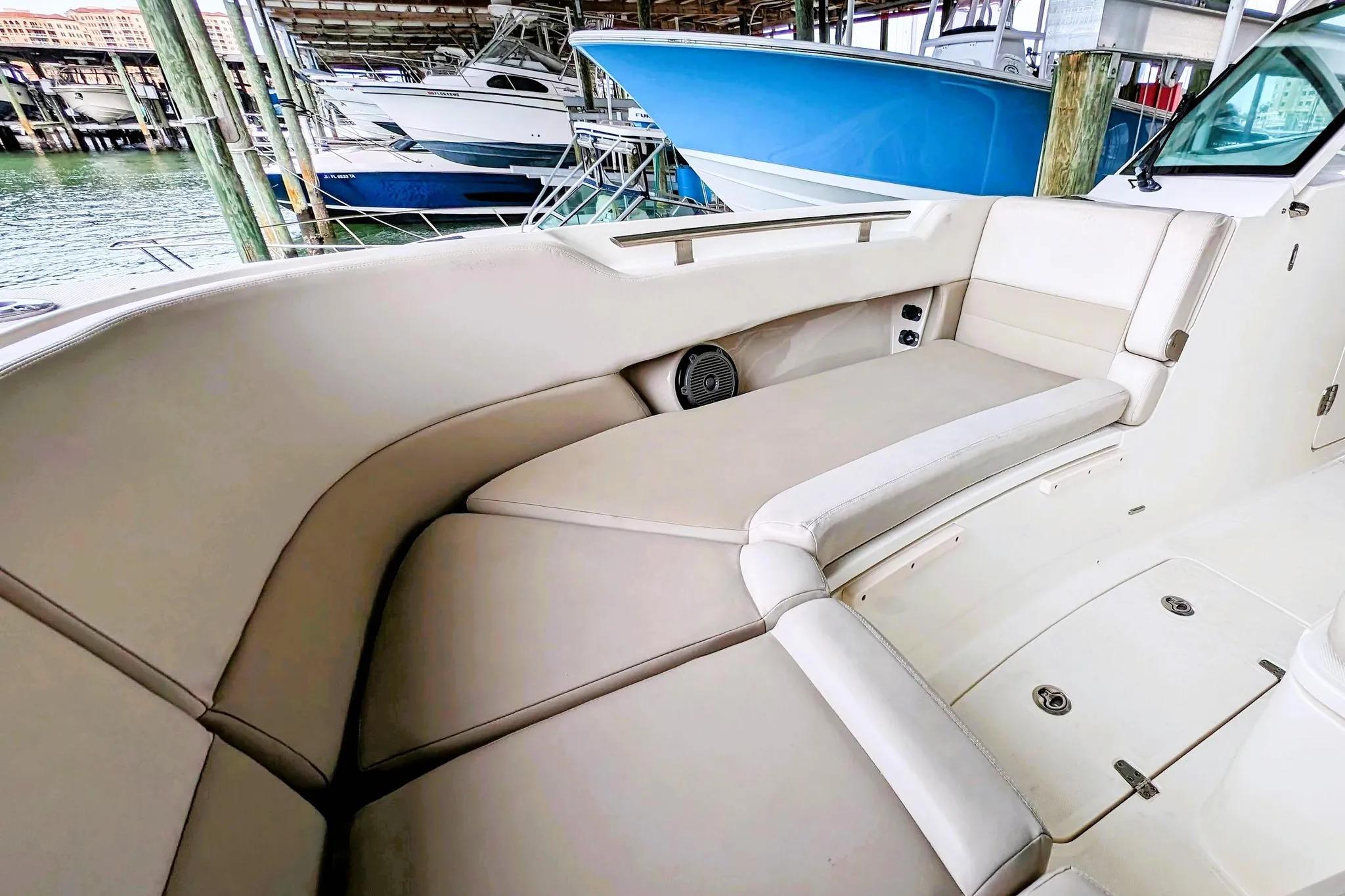 2017 Boston Whaler 320 Vantage boat interior with beige seating in marina.