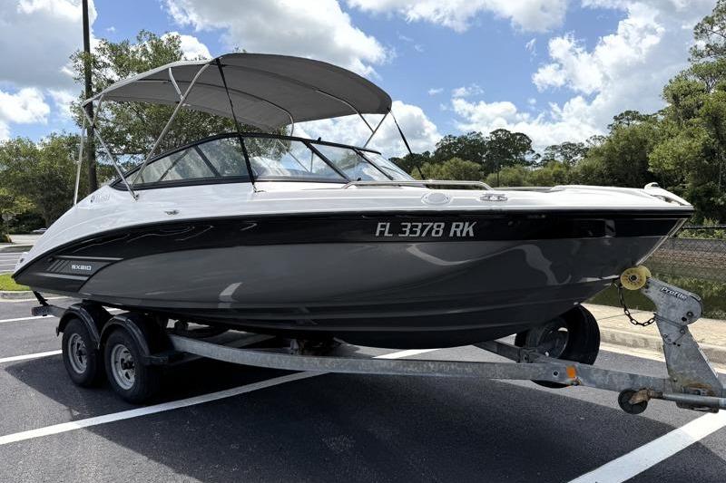 2017 Yamaha Boats SX210 on trailer, parked outdoors under a cloudy sky.