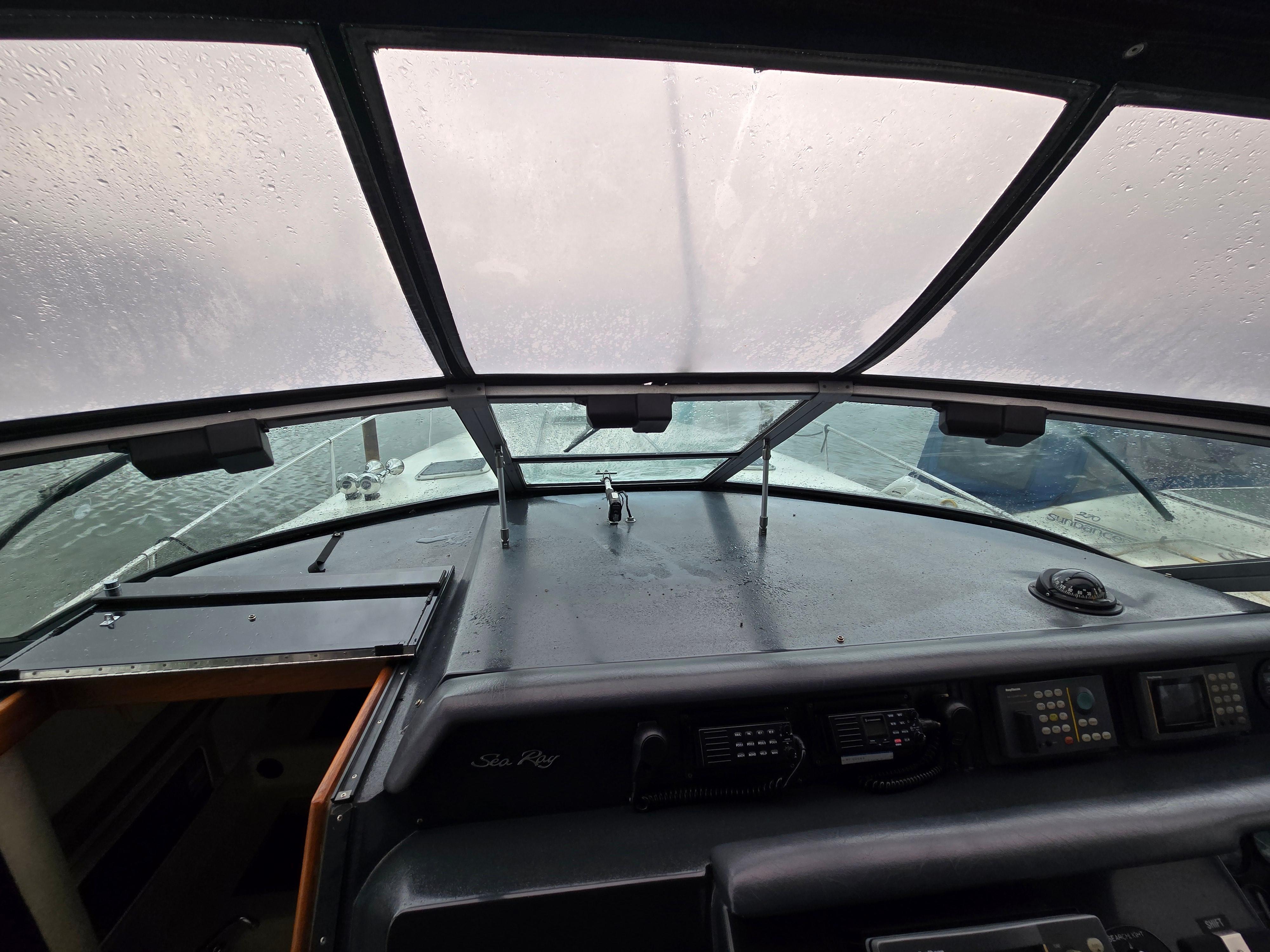 Interior view of 1993 Sea Ray 330 Express Cruiser cockpit with windshield.