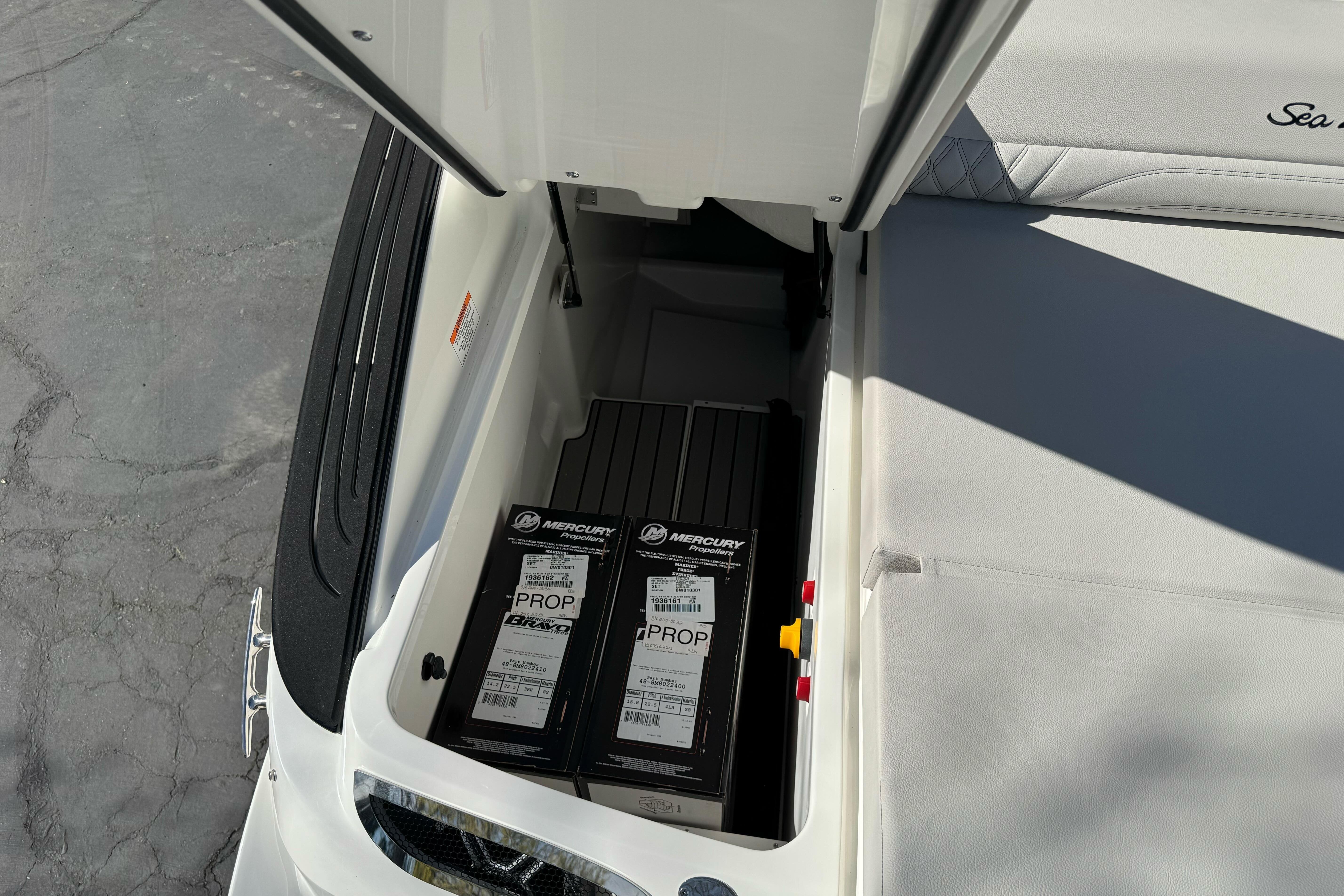 Storage compartment of 2026 Sea Ray SLX 260 boat with Mercury propeller boxes.
