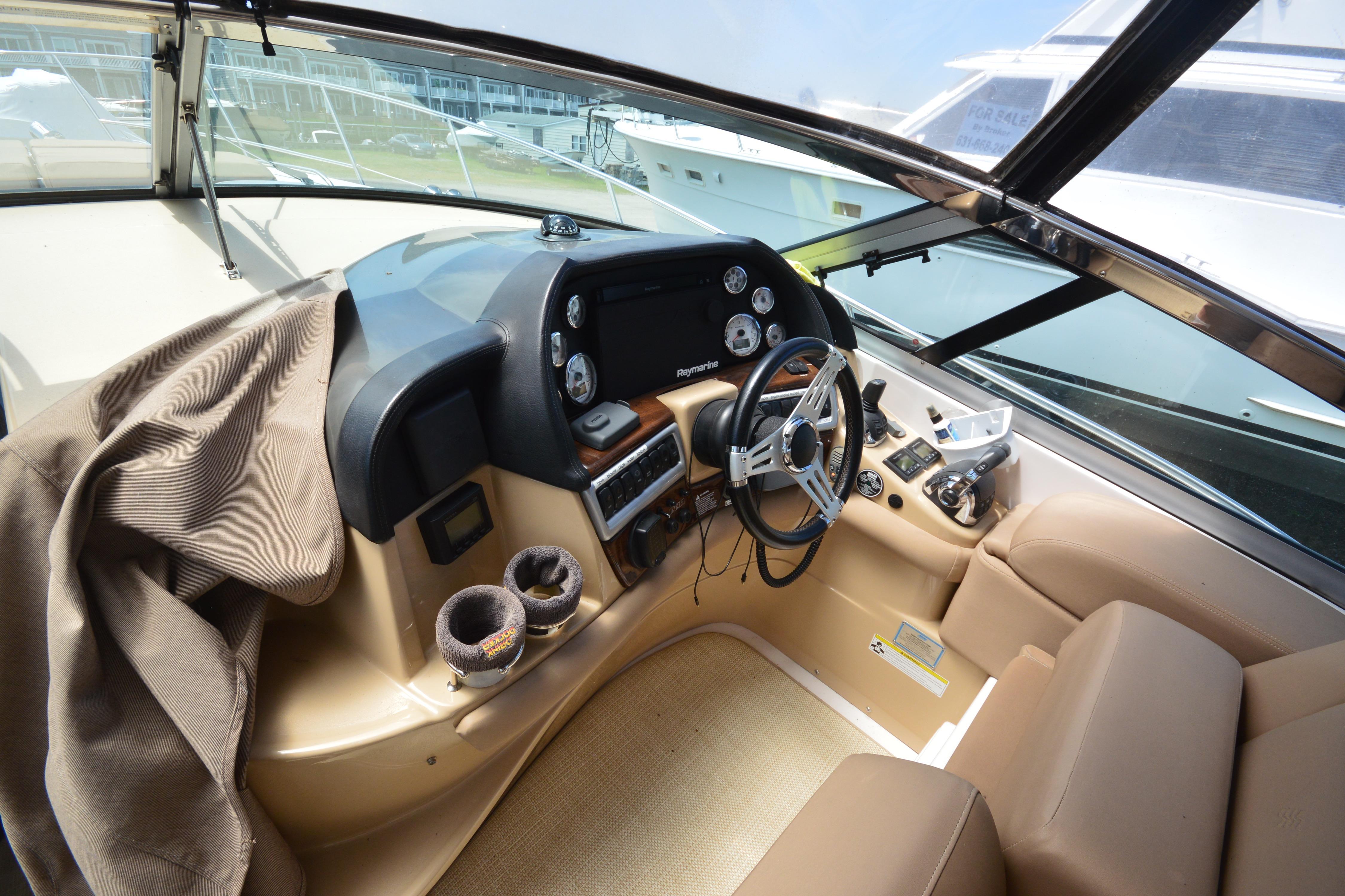 2013 Four Winns V375 boat cockpit with steering wheel and navigation controls.