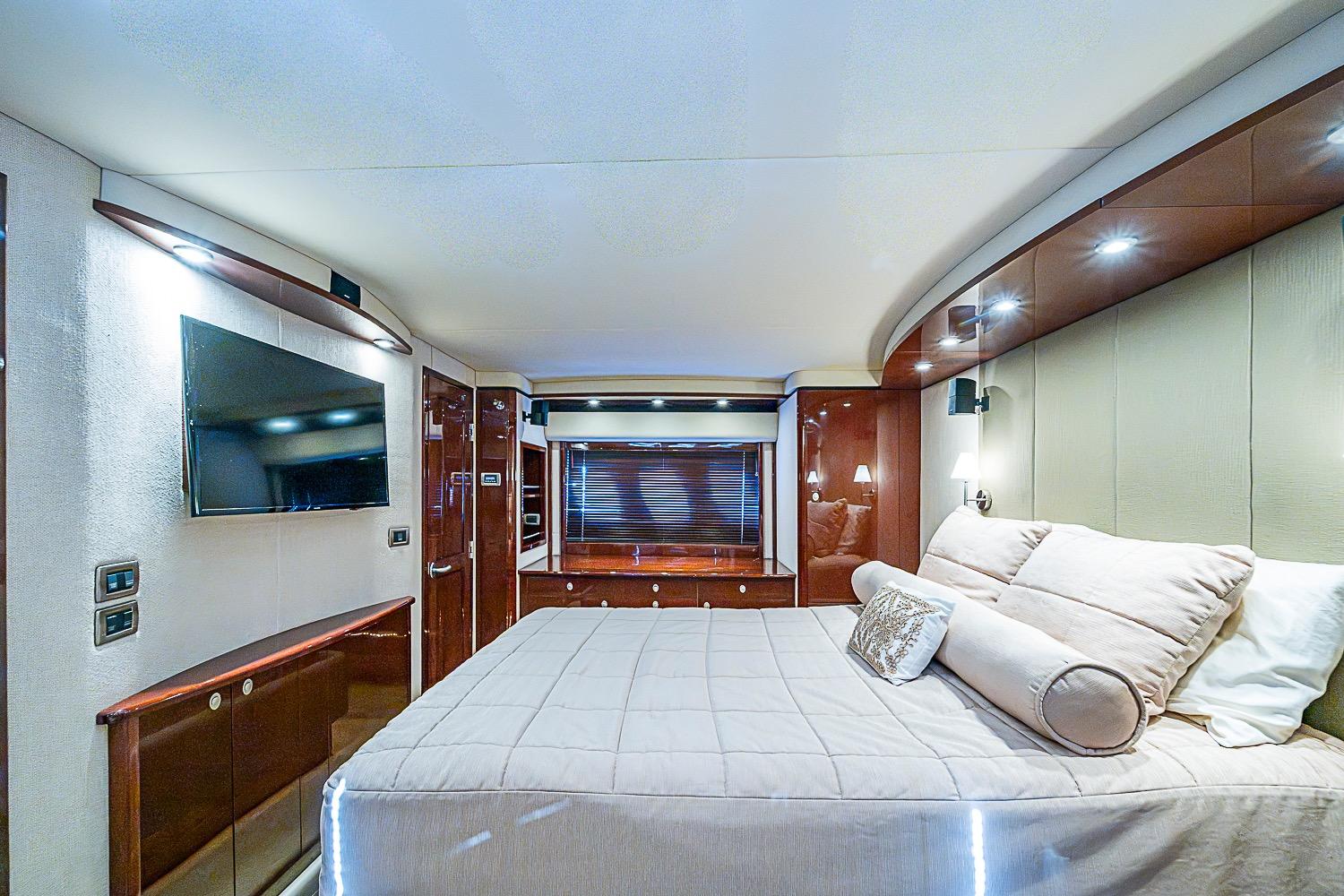 Luxurious bedroom interior of 2008 Sea Ray 60 Sundancer yacht with modern amenities.