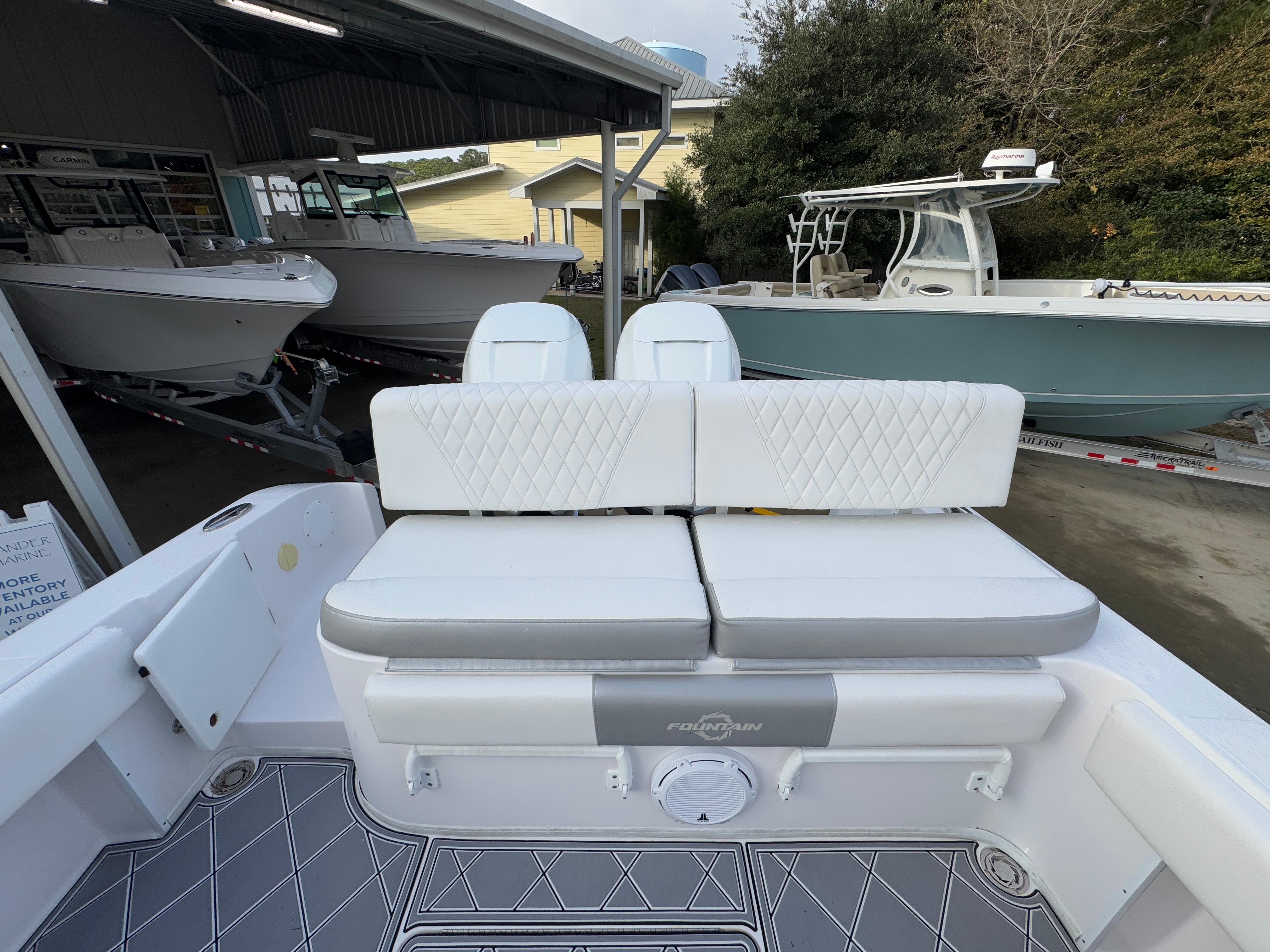 2018 Fountain 34 CC boat interior with white cushioned seating and sleek design.