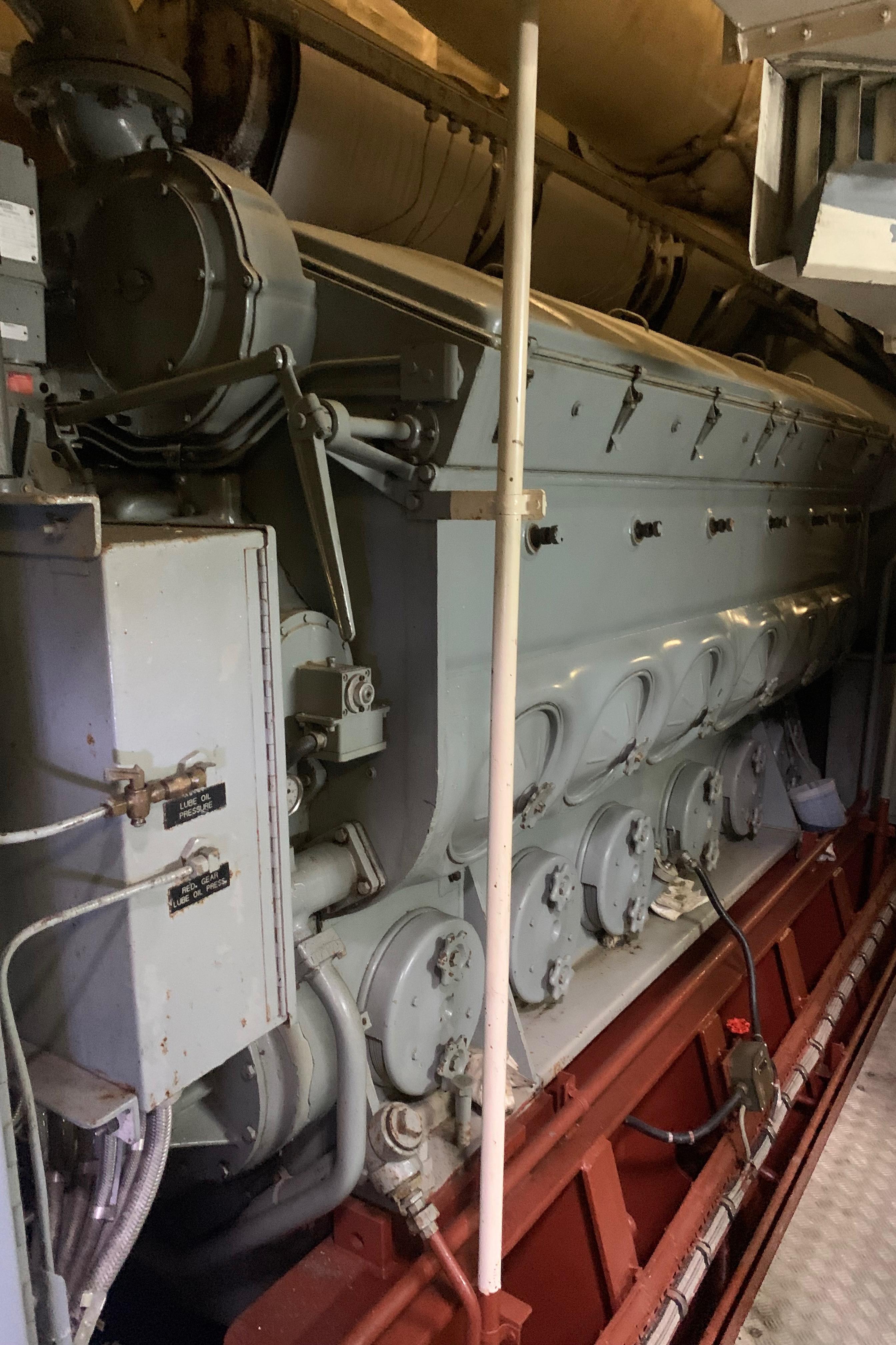 Engine room of 1955 Tugboat L-T 100 Steel Army Tug, showcasing machinery.