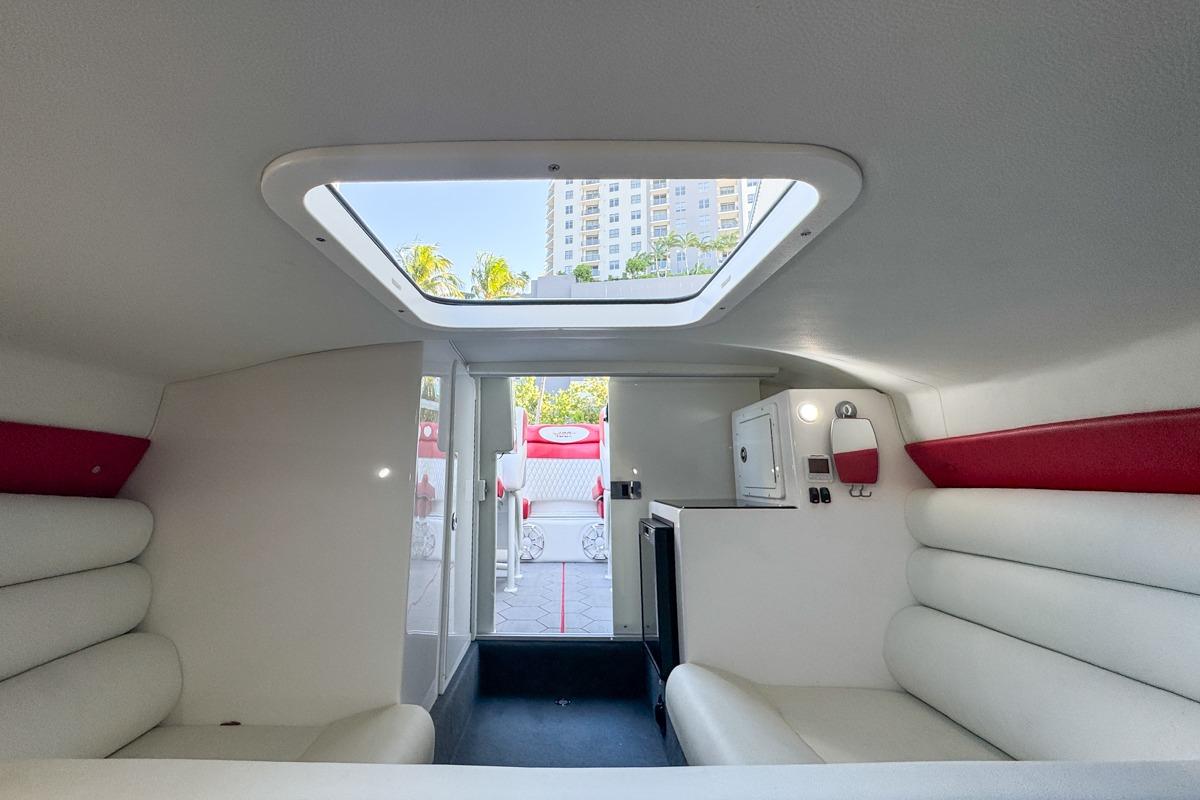Interior of 2022 Velocity 290sc boat with white seating and skylight.