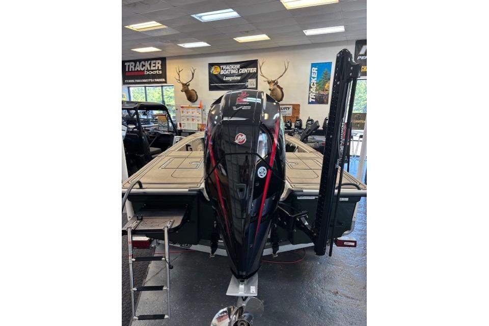 2025 Mako 18 Pro Skiff Backwater Edition displayed in showroom with powerful outboard motor.