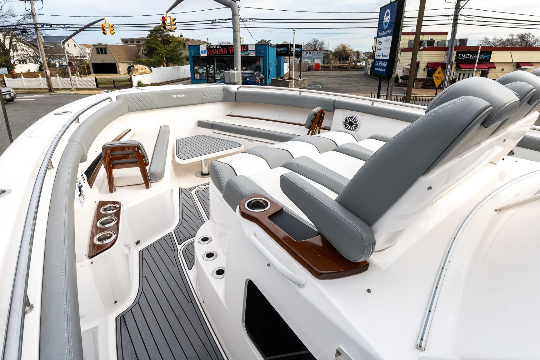 2023 Everglades 455 Center Console boat interior with seating and cup holders.
