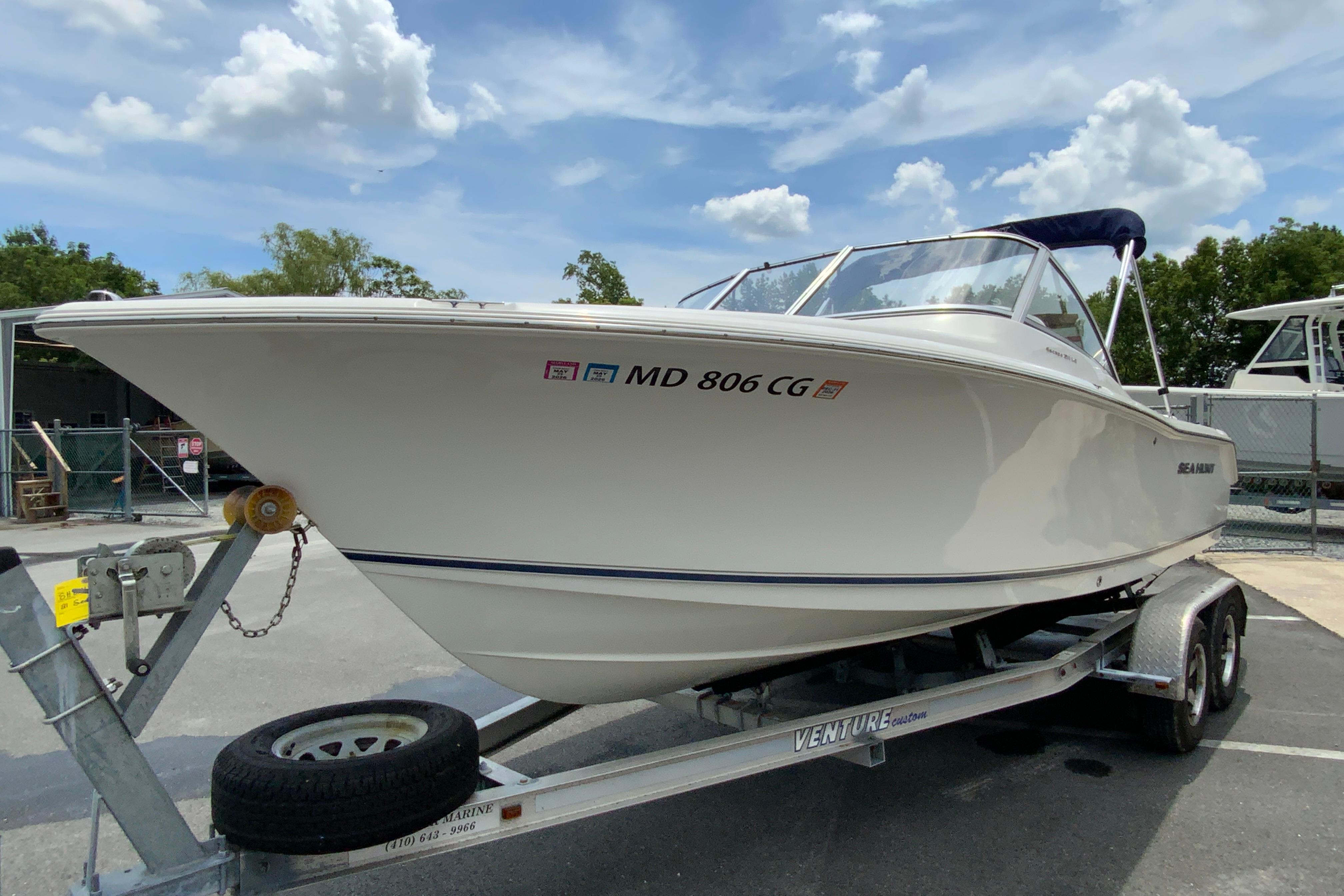 2014 Sea Hunt Escape 211 LE boat on trailer under blue sky.