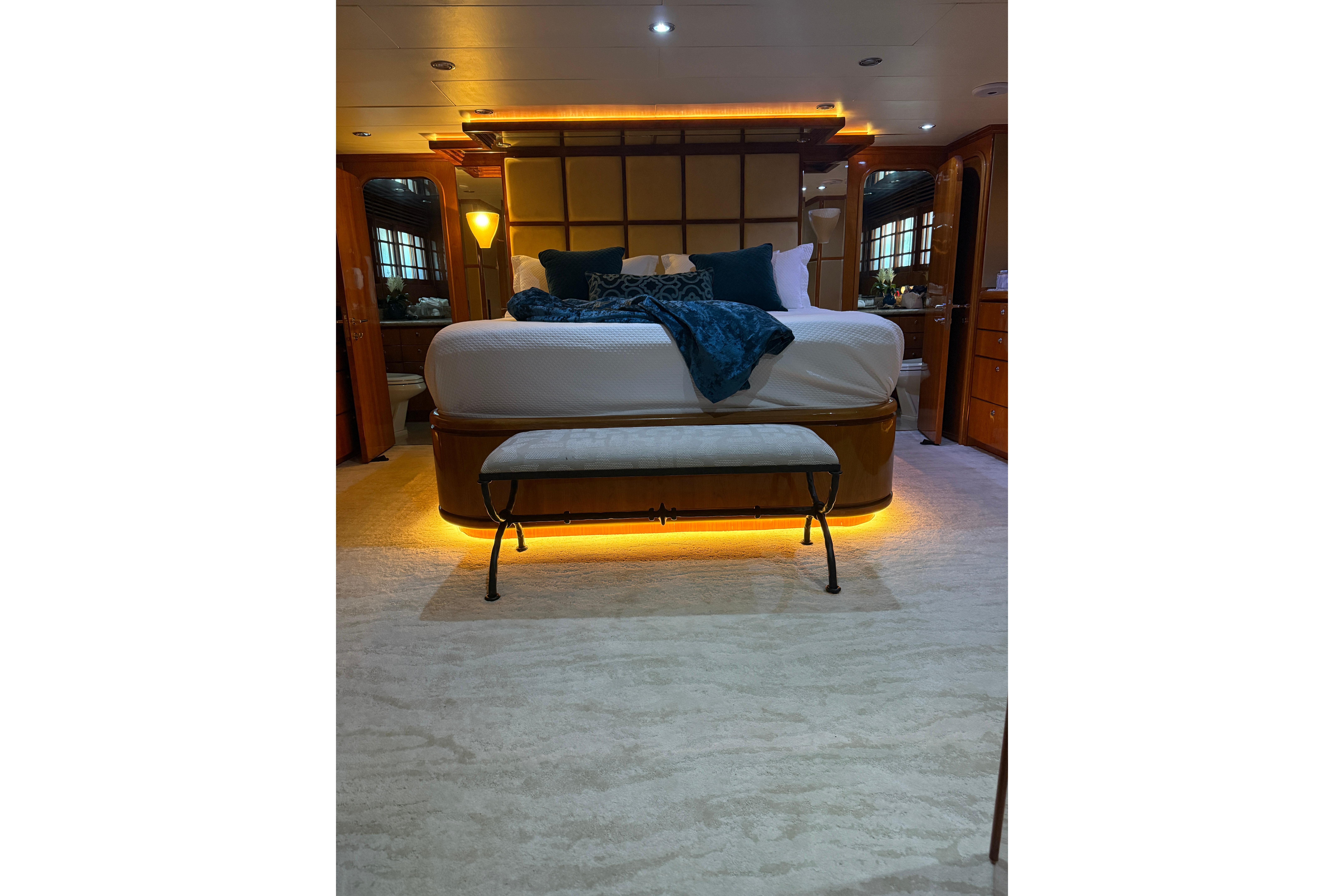 Luxurious bedroom interior on a 2001 Hargrave 94 yacht, featuring elegant lighting and plush bedding.