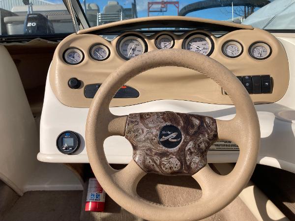 2001 Sea Ray 180 Bow Rider dashboard with steering wheel and gauges.