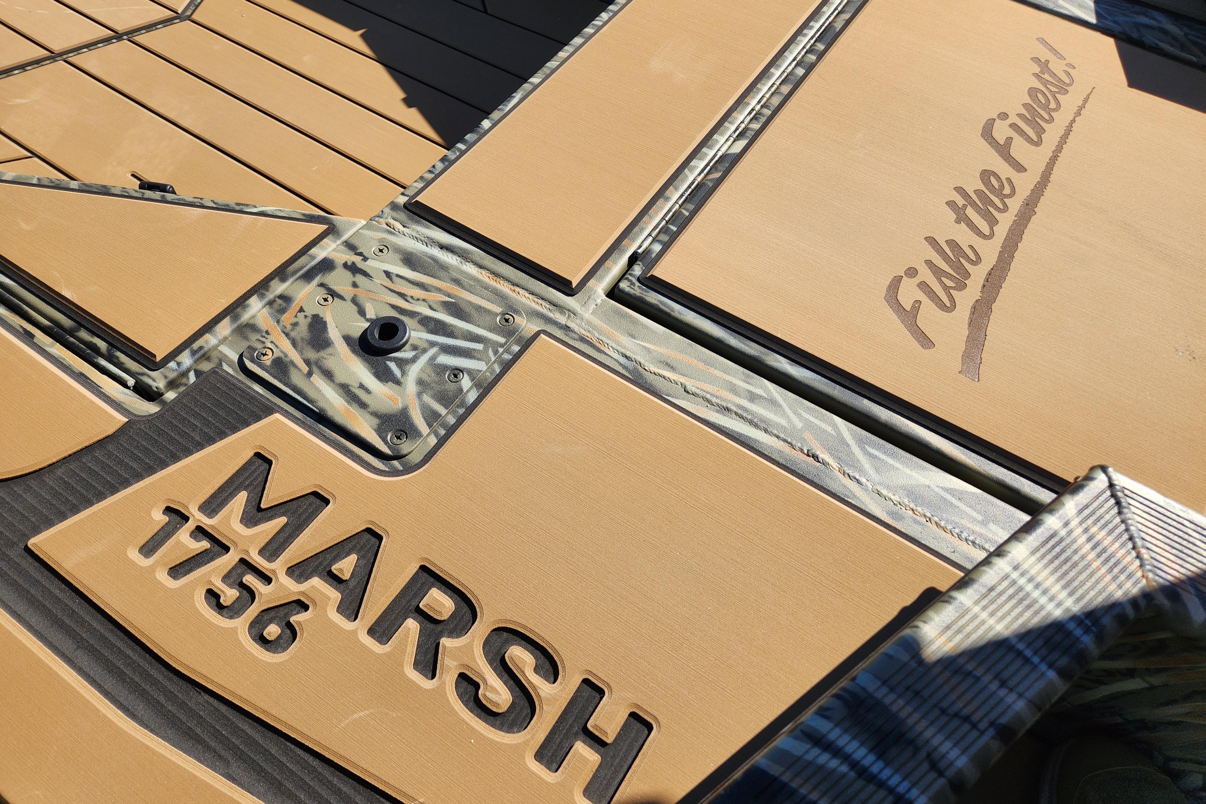 2026 Tracker Grizzly 1756 T Marsh boat deck with "Fish the Finest" slogan.
