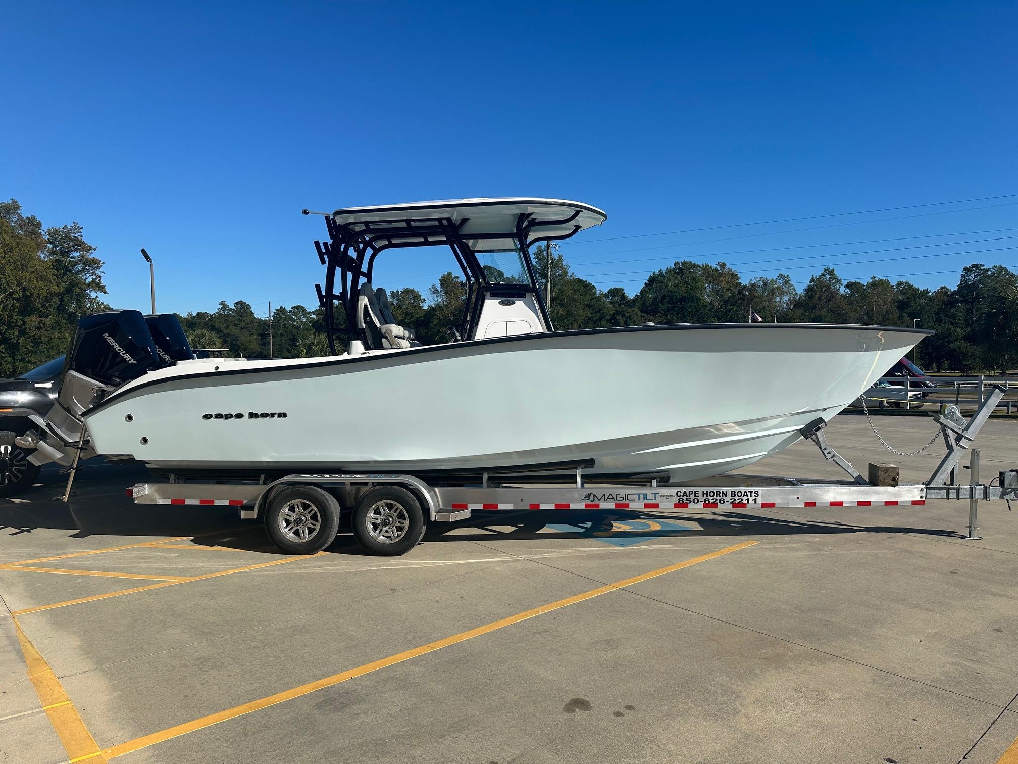 2025 Cape Horn 28XS boat on trailer in parking lot under clear blue sky.