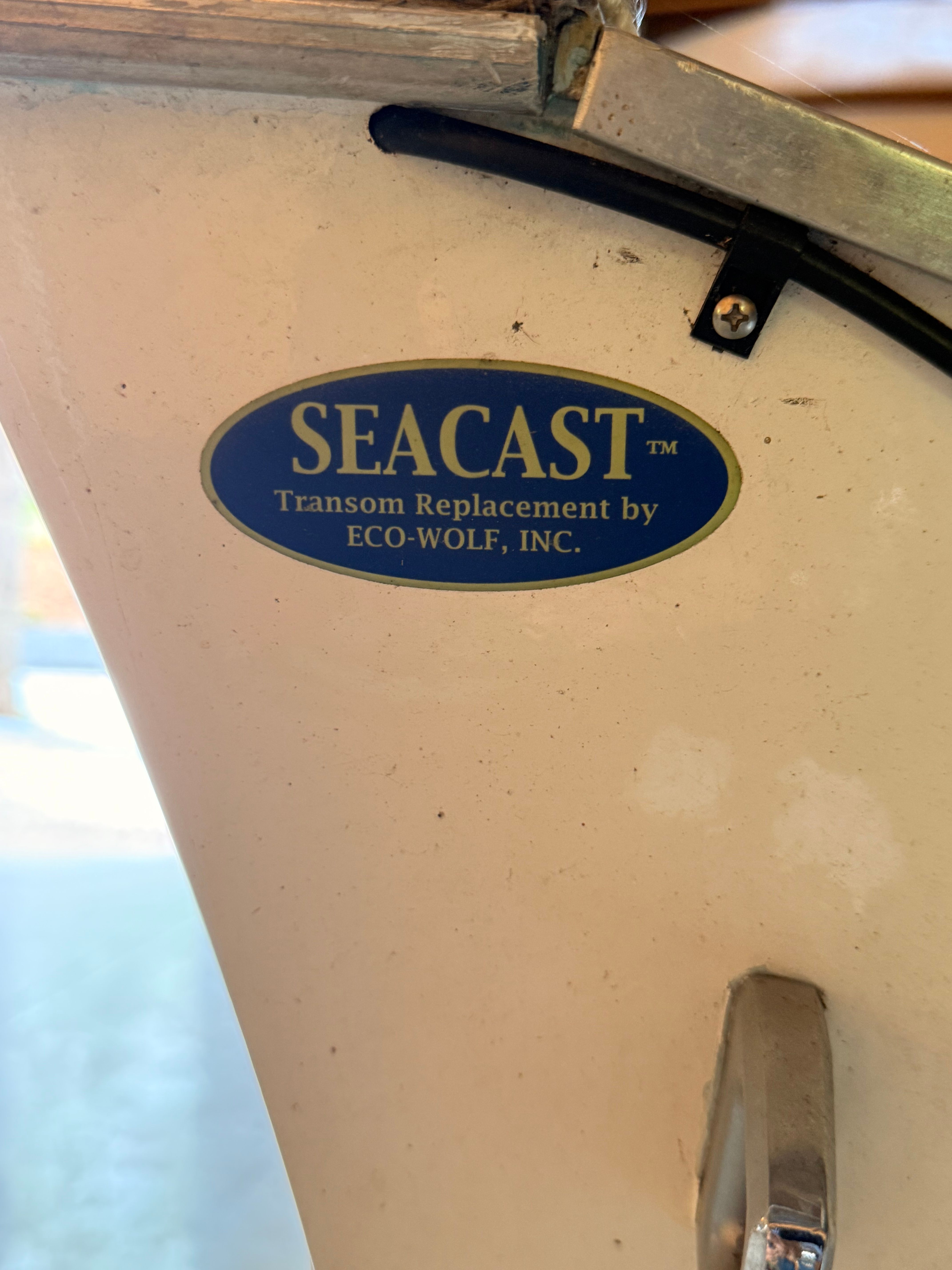 Close-up of a boat with a SEACAST transom replacement label by ECO-WOLF, INC.