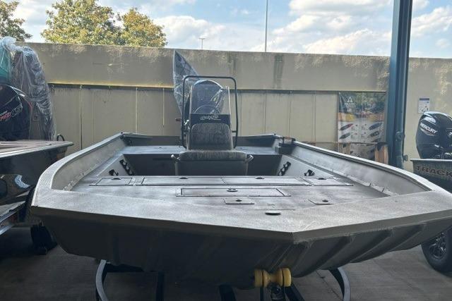 2026 Tracker Grizzly 2072 CC boat displayed in a showroom, highlighting its spacious deck.