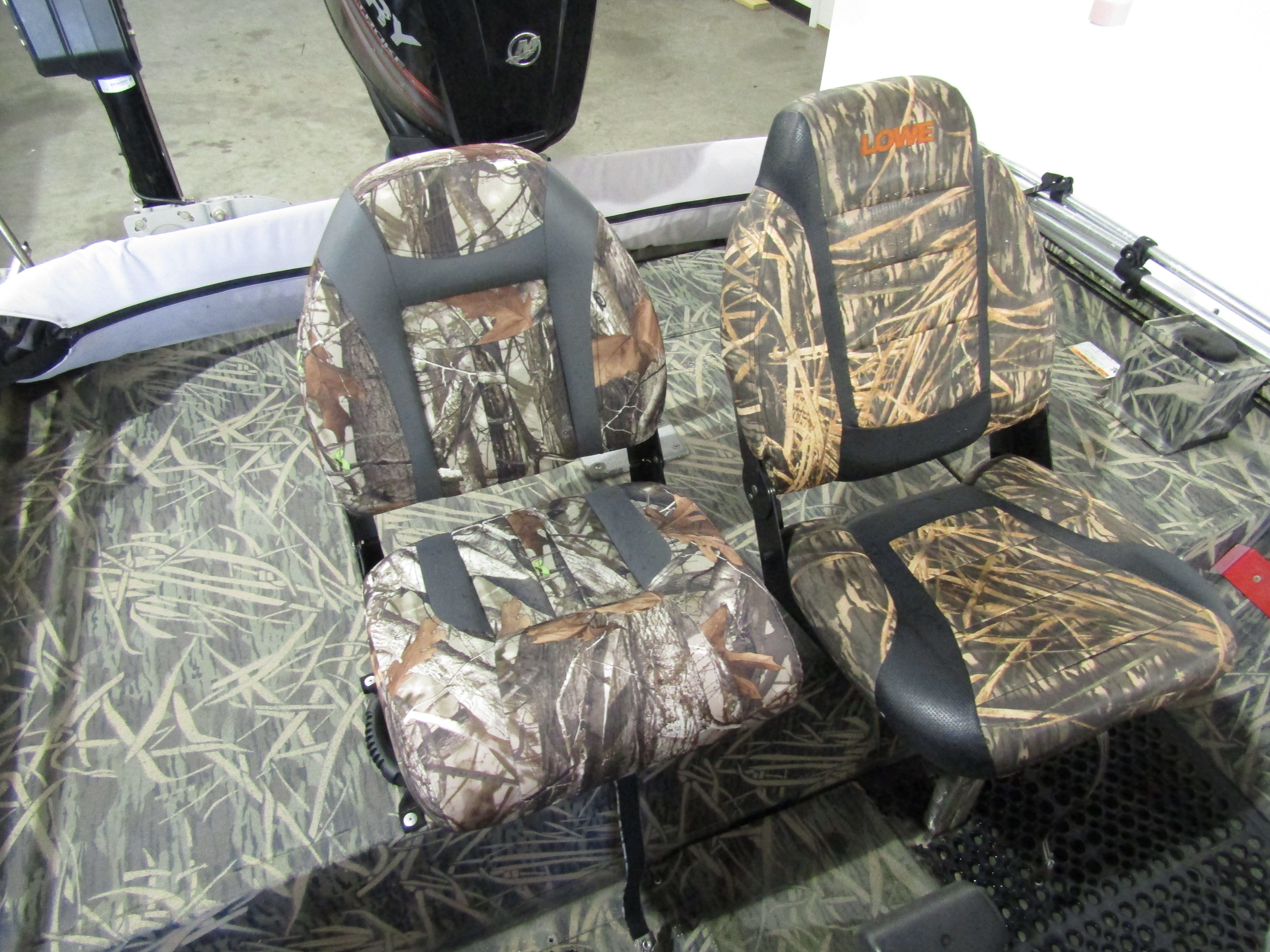 Two camo-patterned padded seats in a boat.