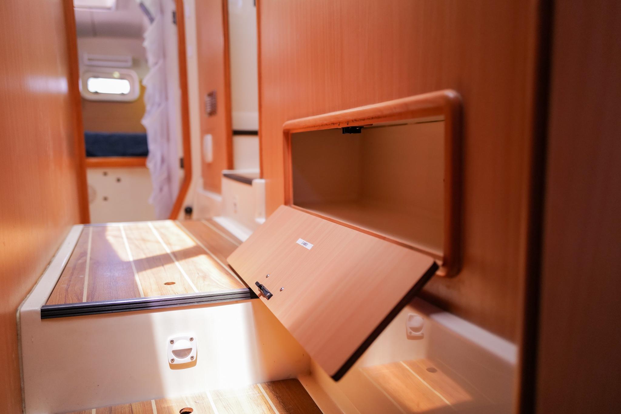 Interior of a 2006 Leopard 43 yacht, featuring wooden cabinetry and storage compartments.