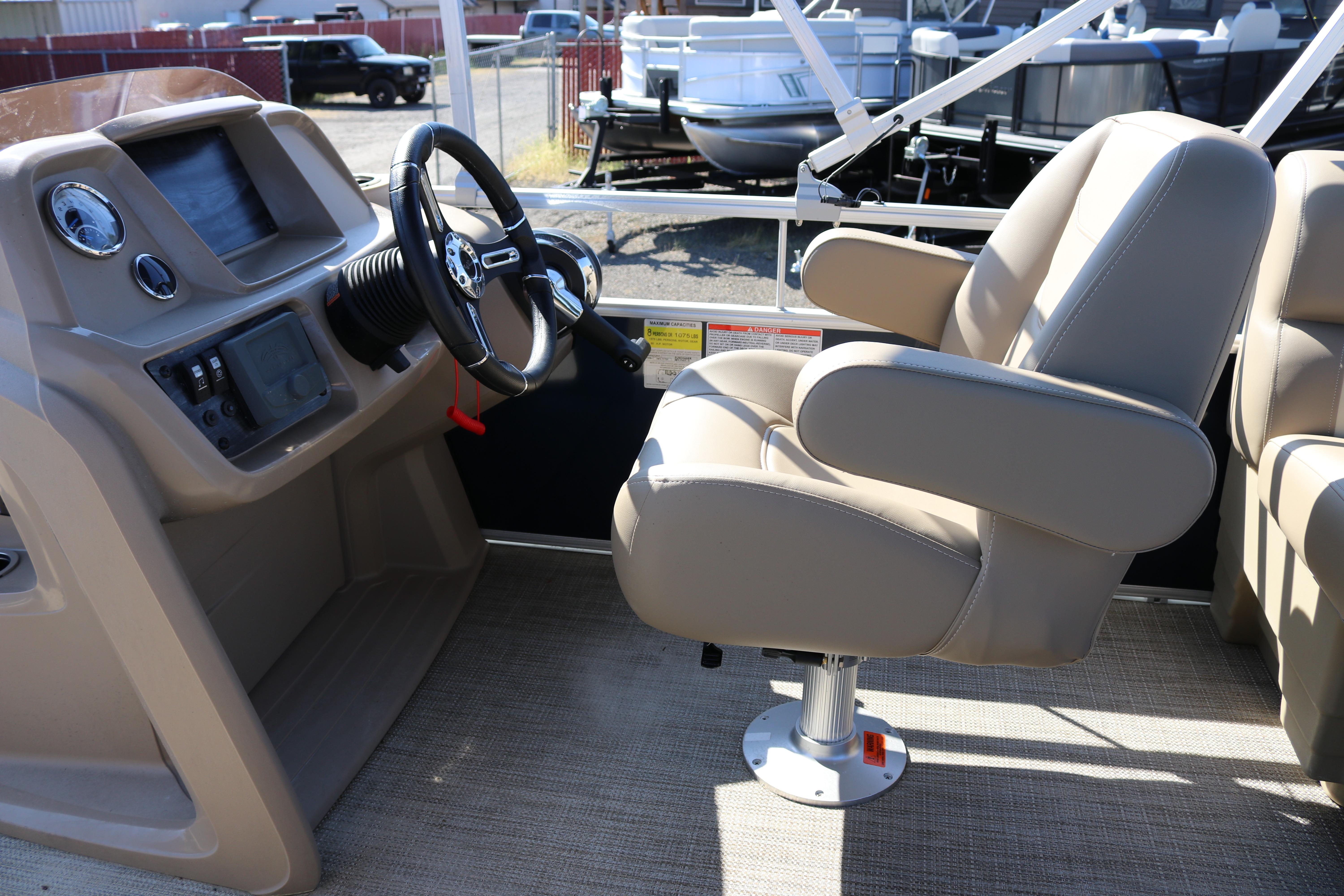 2025 Sun Chaser Vista Fish 18 boat interior with steering wheel and captain's chair.