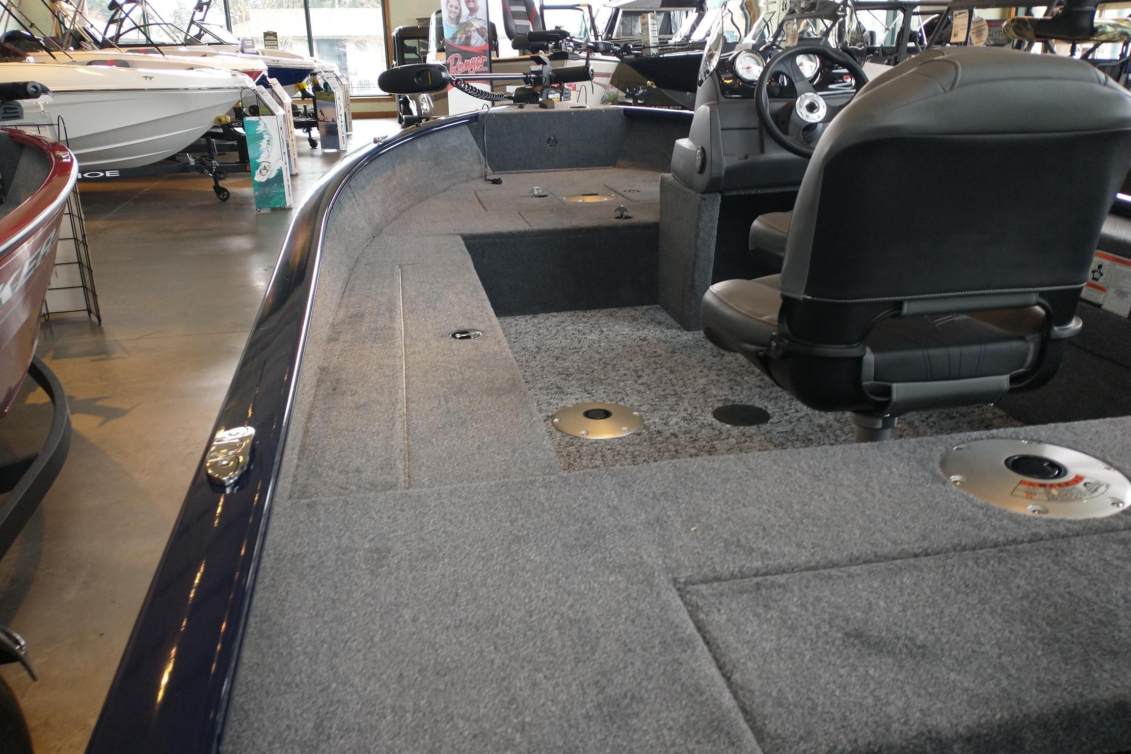 2026 Tracker Super Guide V-16 SC boat interior with seating and steering console.