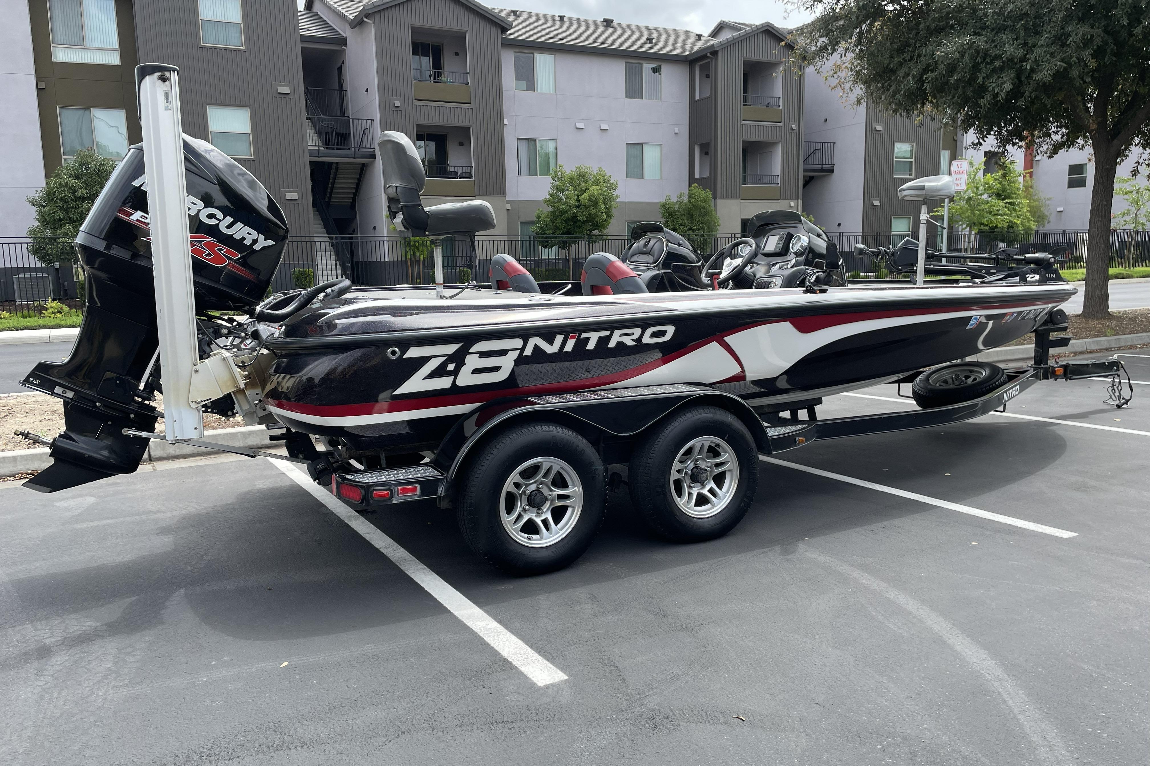 2013 Nitro Z-8 boat with Mercury engine parked in a residential area.